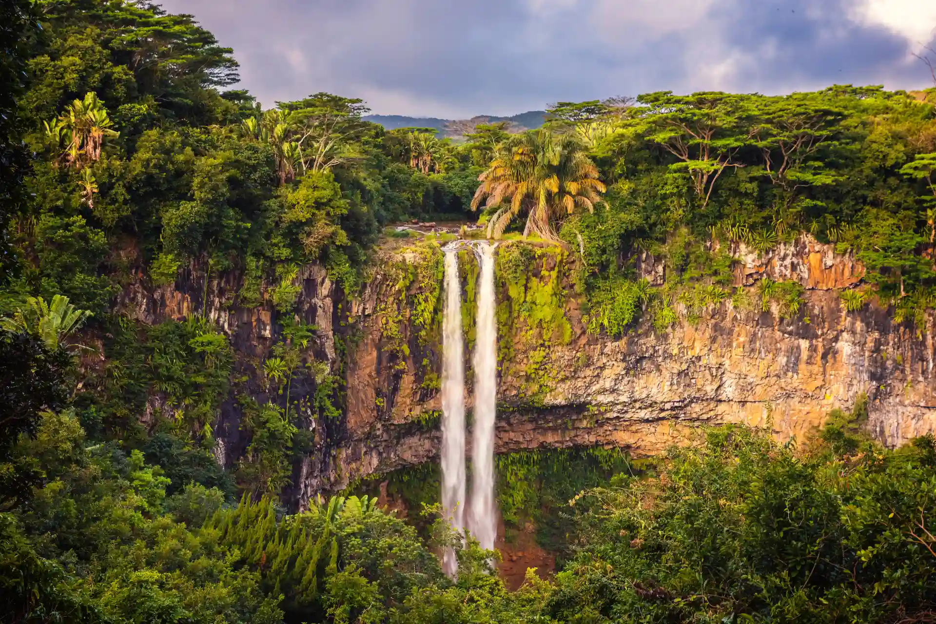 chamarel waterfall mauritius cascading water surrounded by lush green rainforest and rocky cliffs