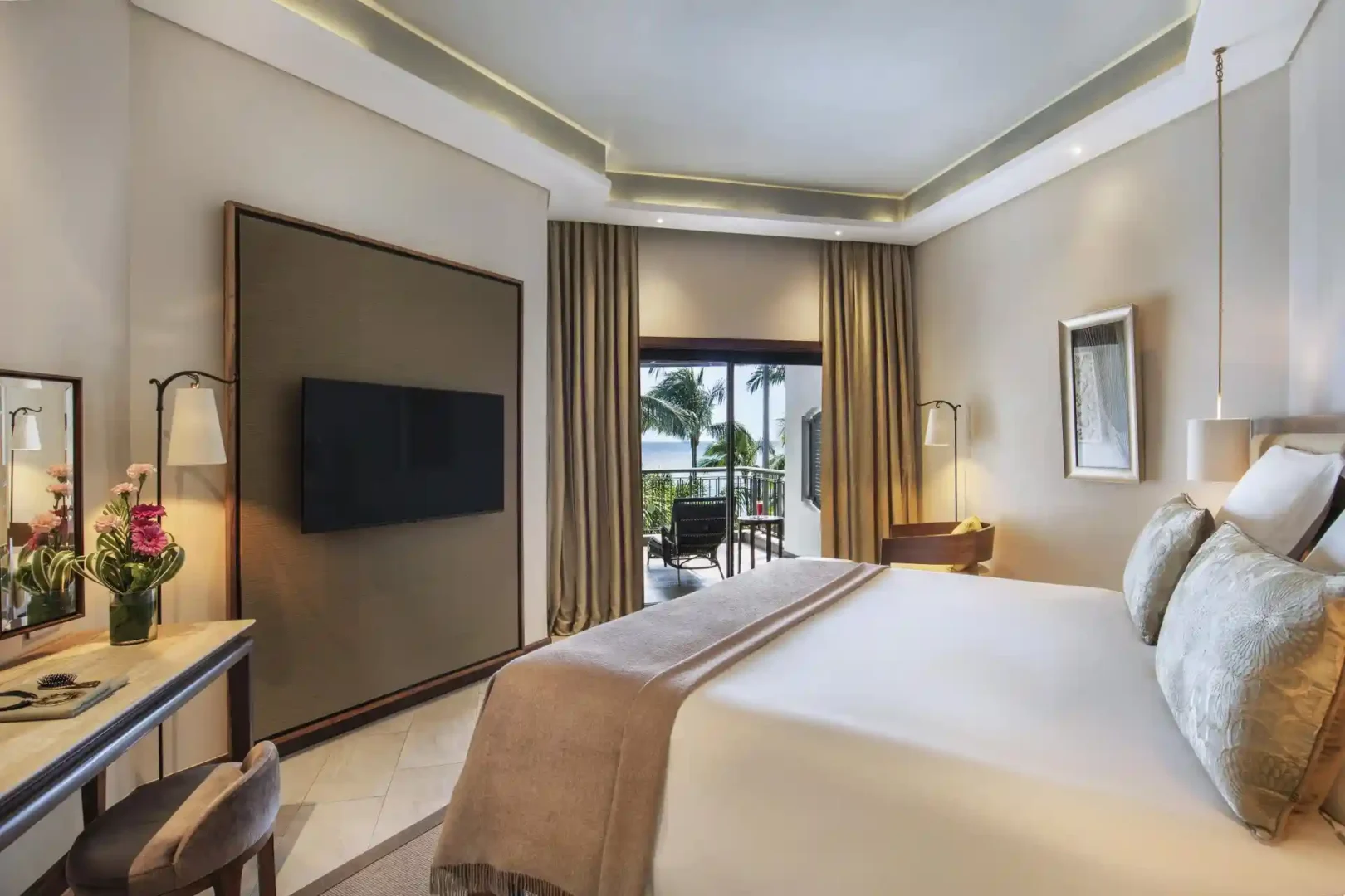 royal palm presidential suite bedroom with balcony, seating area, and view of the surroundings