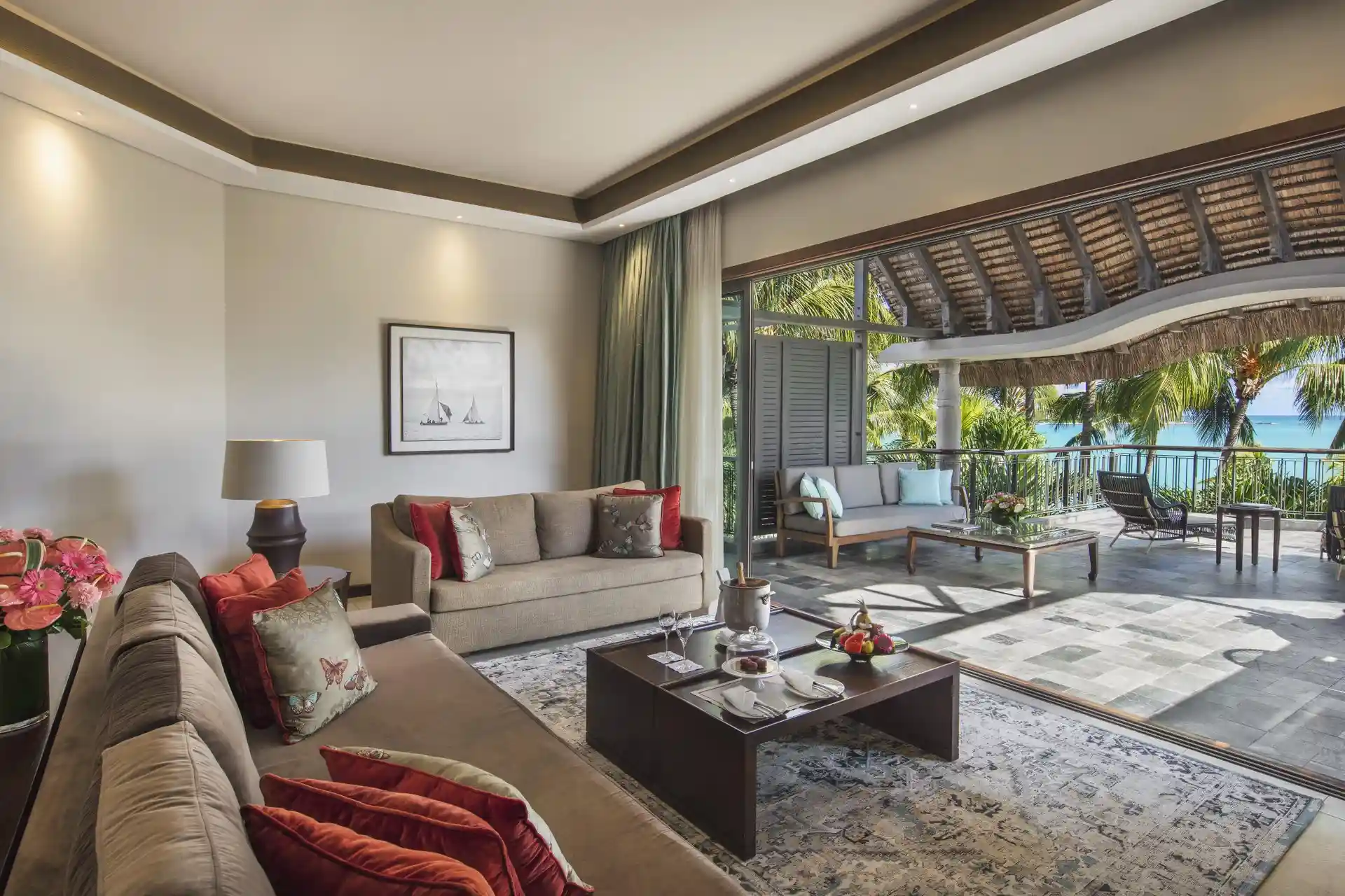 Here’s a lowercase alt text for that image: Alt text: "royal palm presidential suite bedroom with lounge area, including sofa, chairs, coffee table, and windows