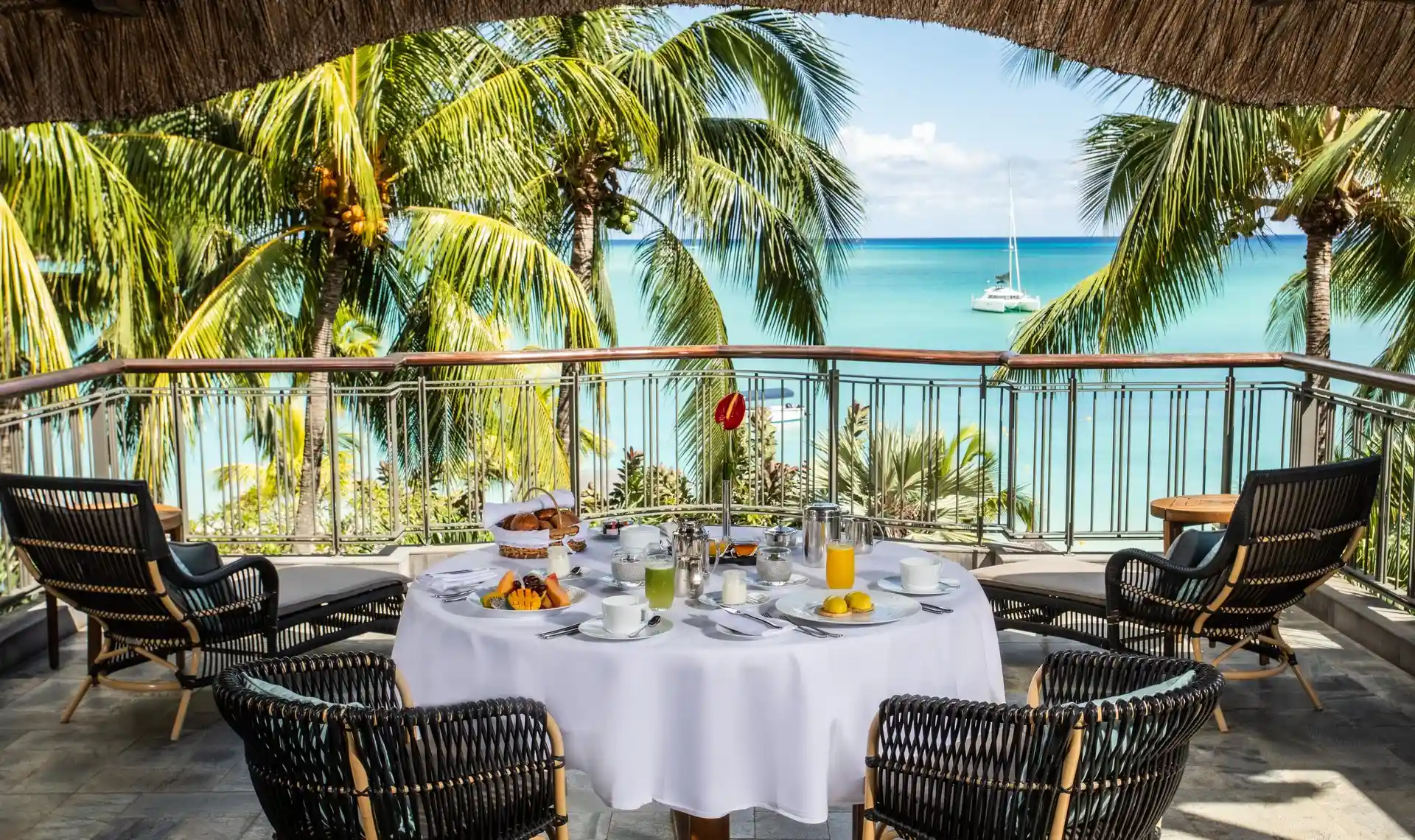 royal palm presidential suite breakfast setup with table, chairs, and assortment of food and beverages