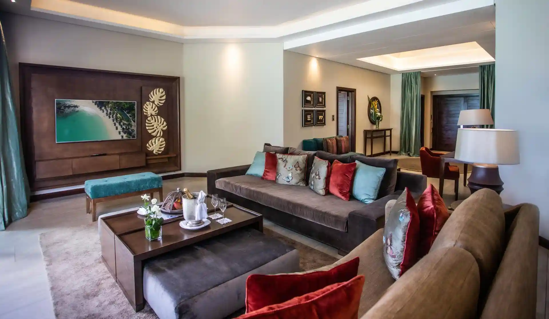 royal palm presidential suite lounge with seating area, sofa, chairs, coffee table, and large windows