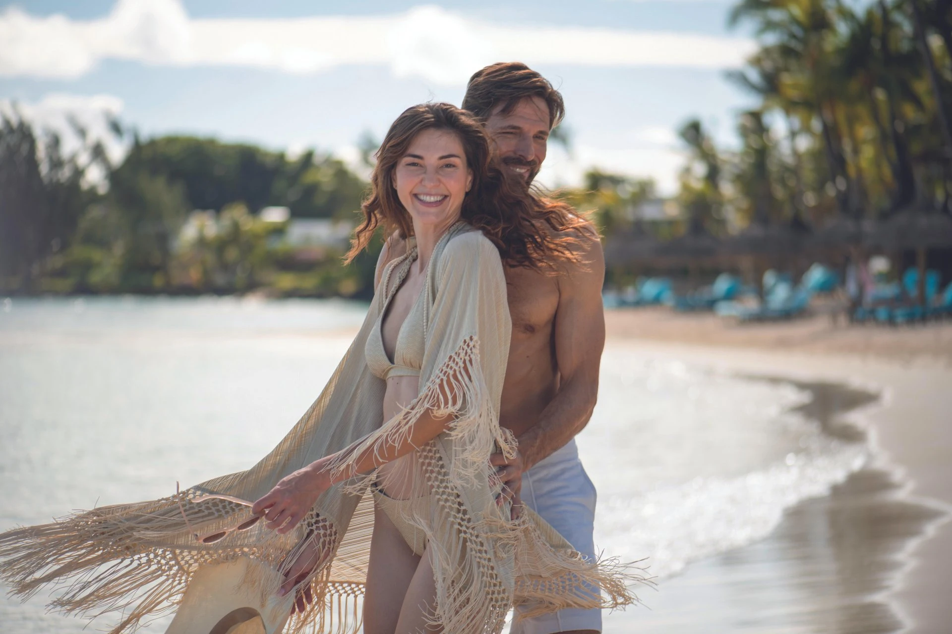royal palm mauritius honeymoon beach with couple walking along tropical shoreline at sunset