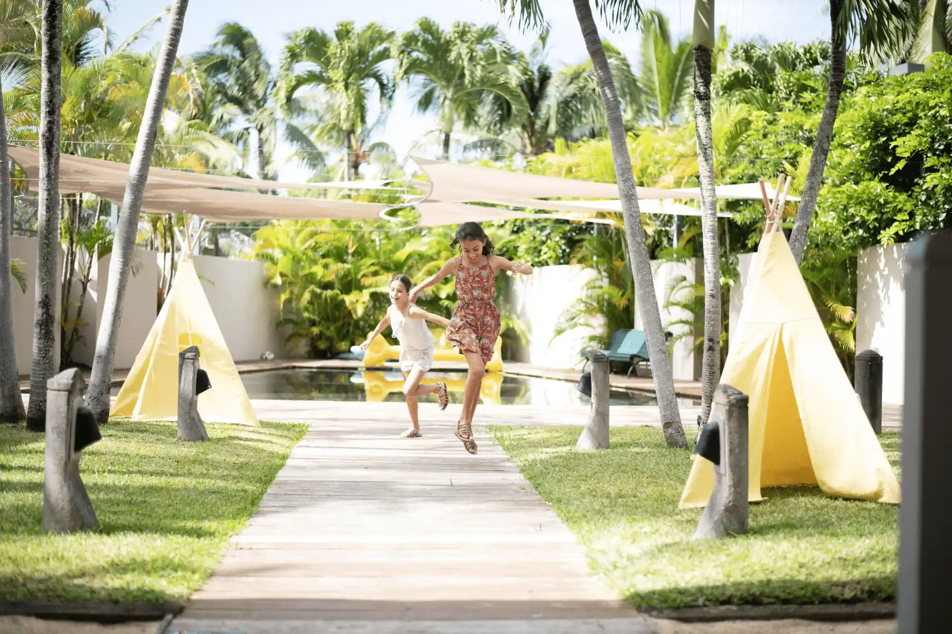 children playing at royal palm mauritius kids club with colorful toys and outdoor activities