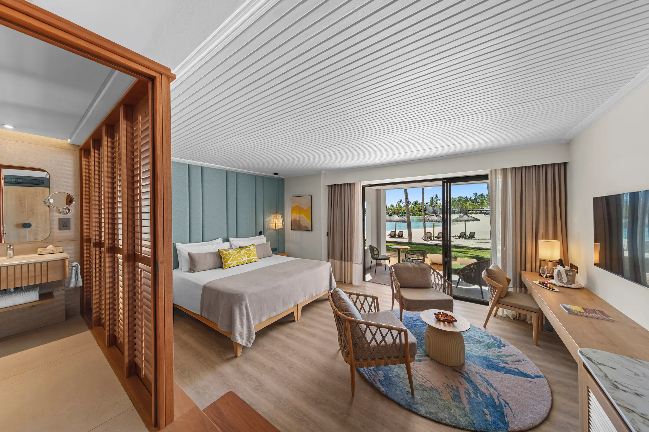 Modern Beach Room interior at Shandrani Beachcomber Mauritius featuring a king-size bed, comfortable seating area and contemporary island-inspired design