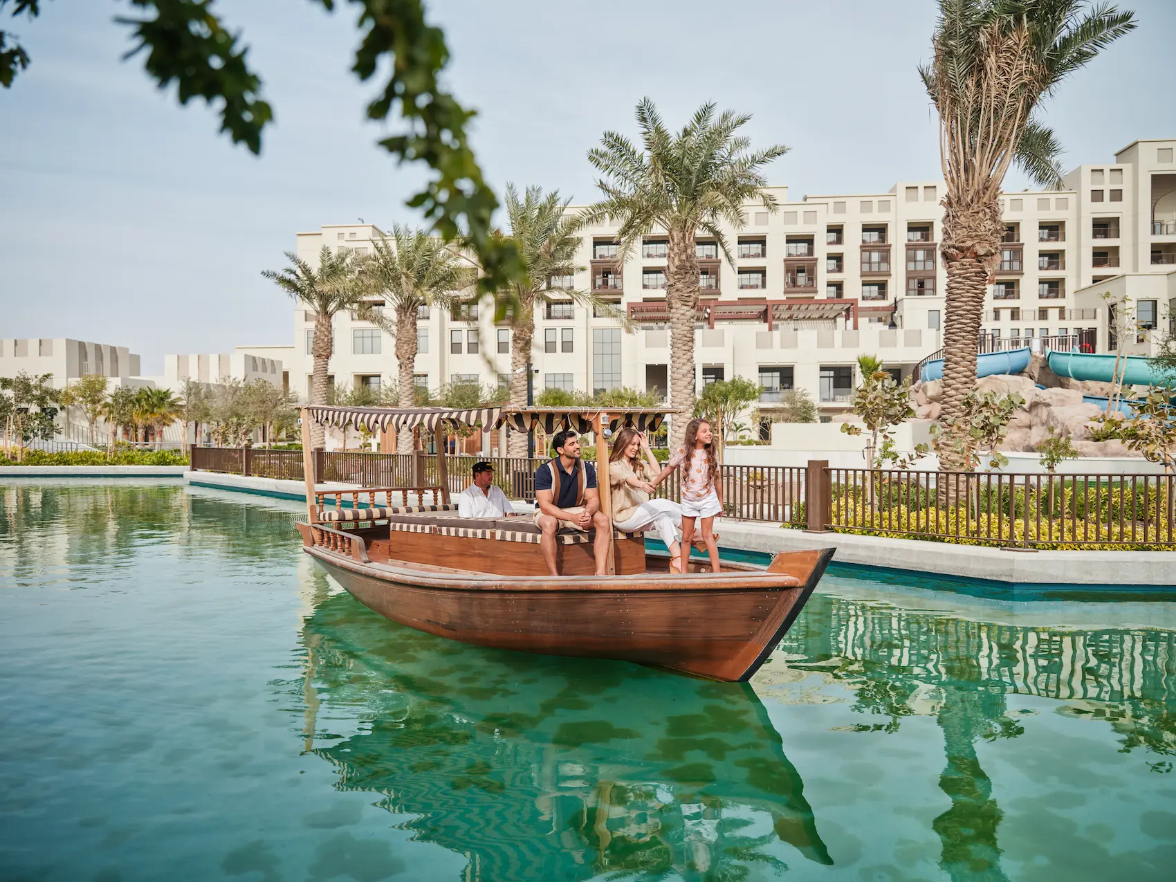 guests enjoying an abra boat tour at jumeirah gulf of bahrain with calm waters and scenic coastal views