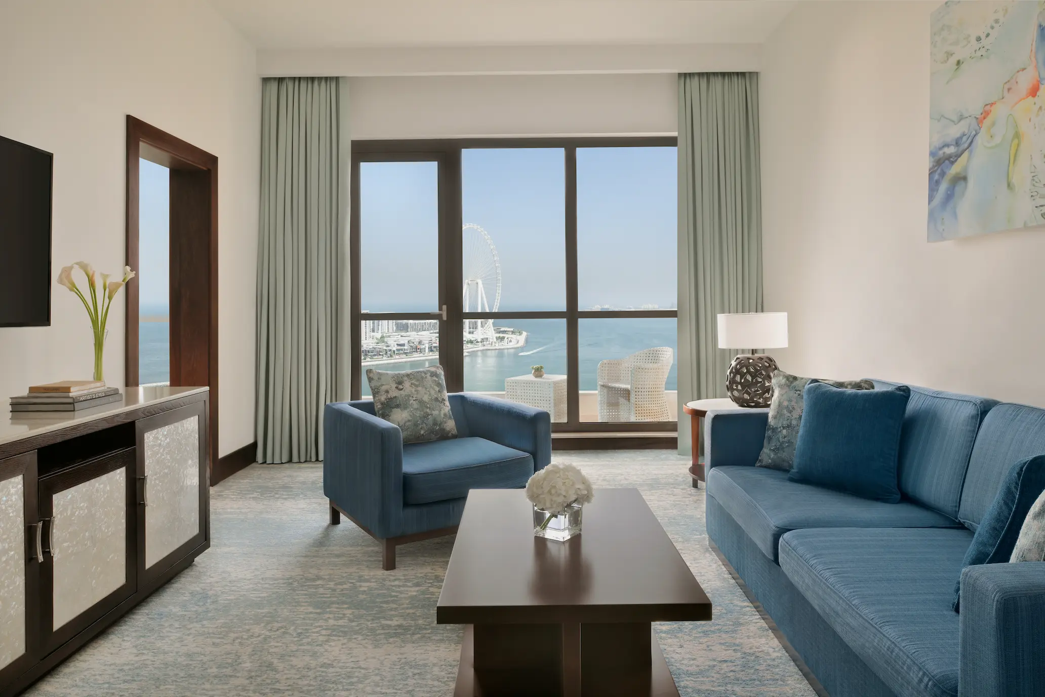 ain dubai view one bedroom family suite lounge at ja ocean view hotel with seating area and contemporary décor