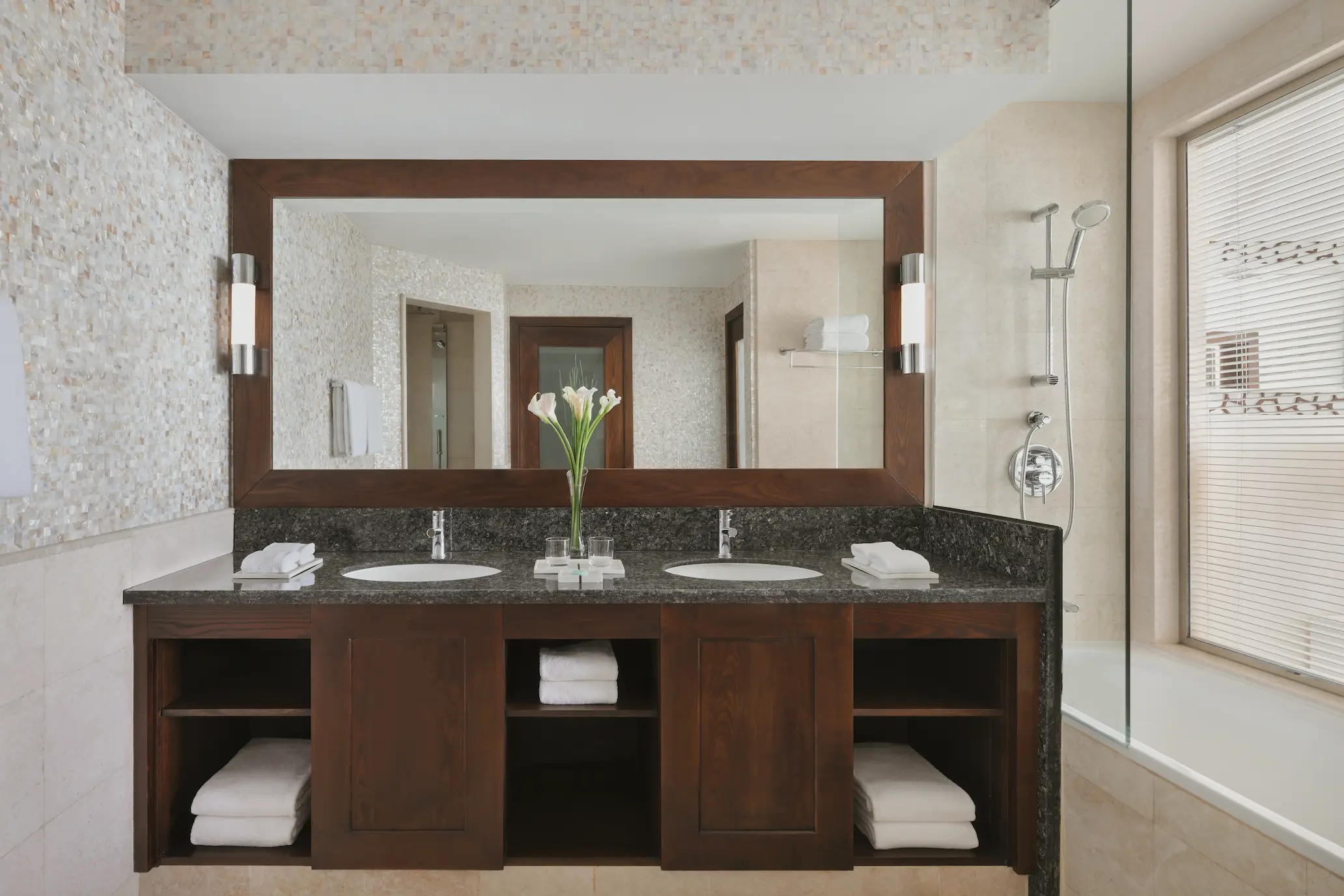 ain dubai view one bedroom family suite sink at ja ocean view hotel with modern vanity and mirror