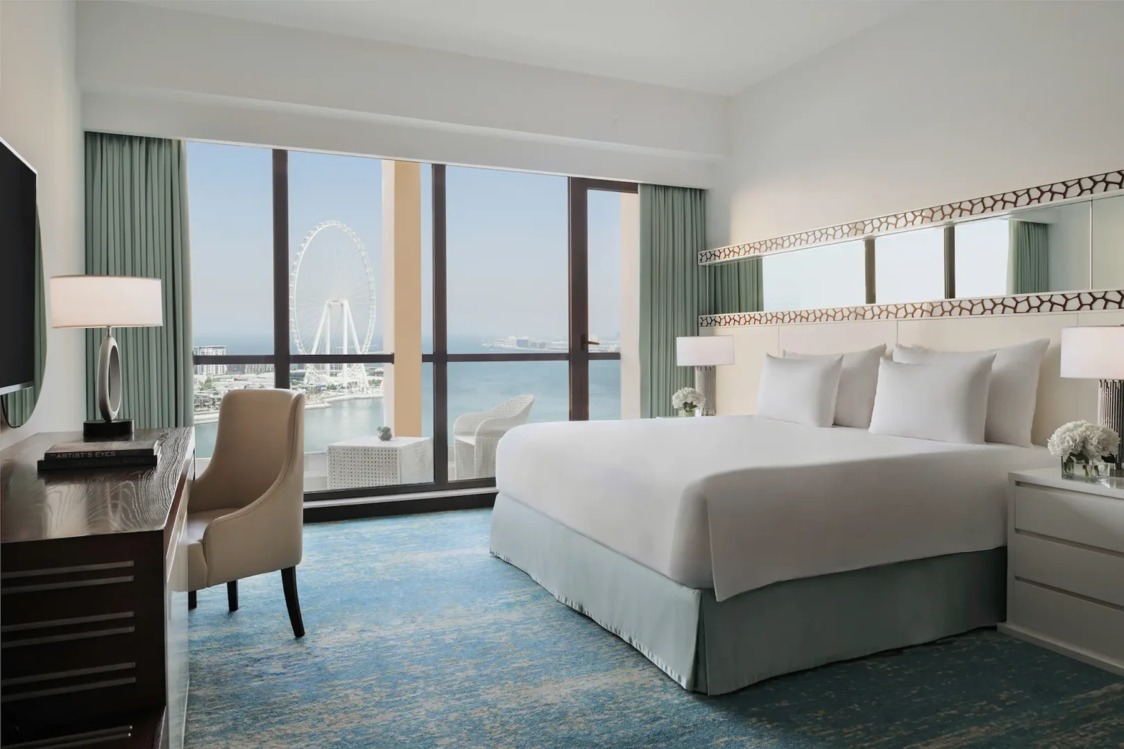 ain dubai view room at ja ocean view hotel with work desk and seating area