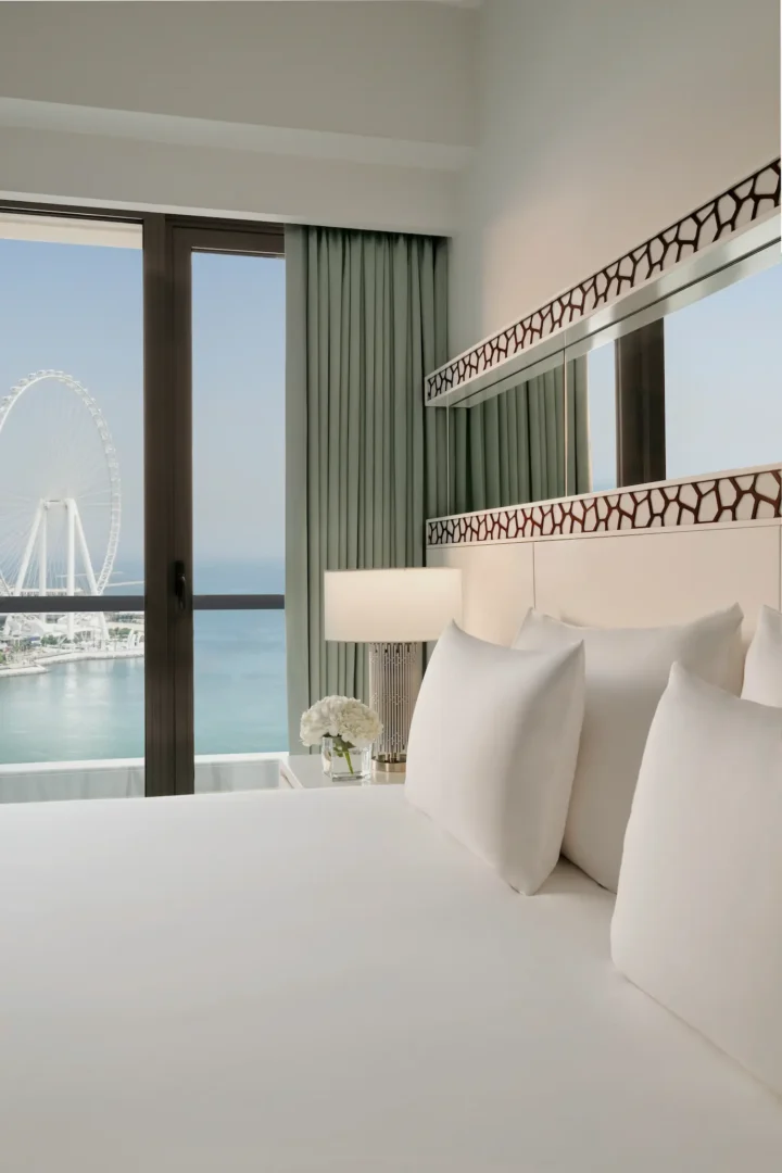 ain dubai view room at ja ocean view hotel with bed and decorative pillows