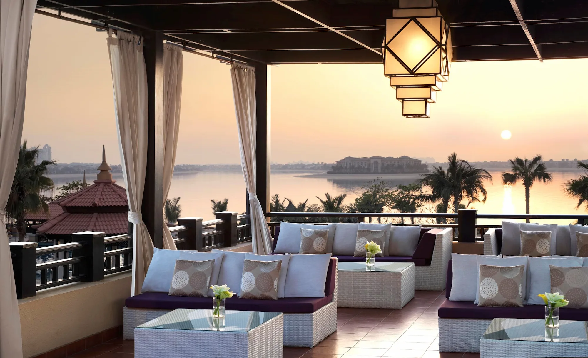 Outdoor seating at The Lotus Lounge, Anantara The Palm Dubai Resort, with views of the Arabian Gulf
