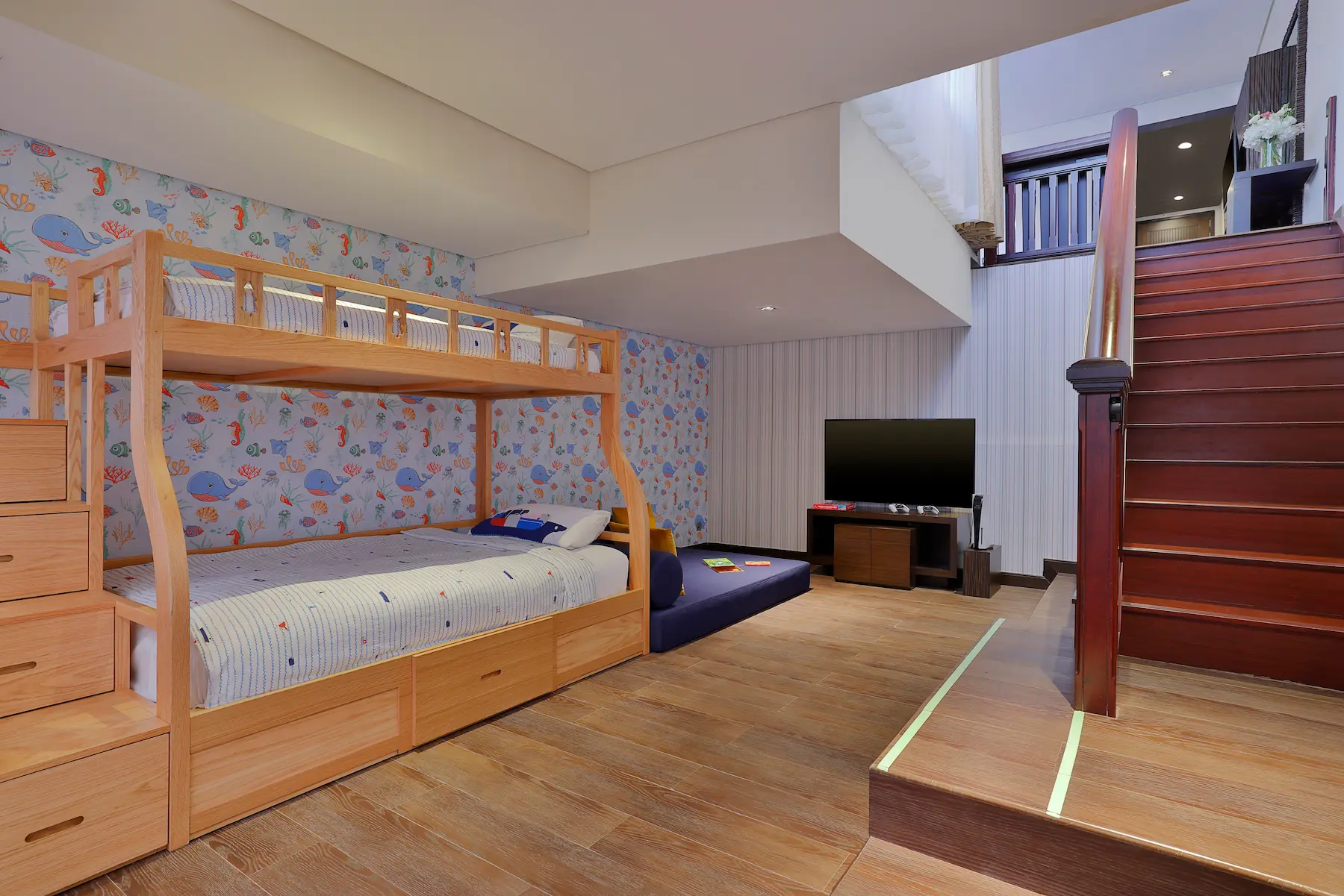 Deluxe Family Lagoon Access Room at Anantara The Palm Dubai featuring stairs, TV, and kids’ play area