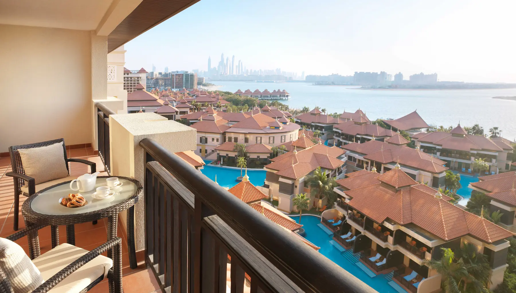 One-Bedroom Apartment balcony at Anantara The Palm Dubai with lagoon views and outdoor seating
