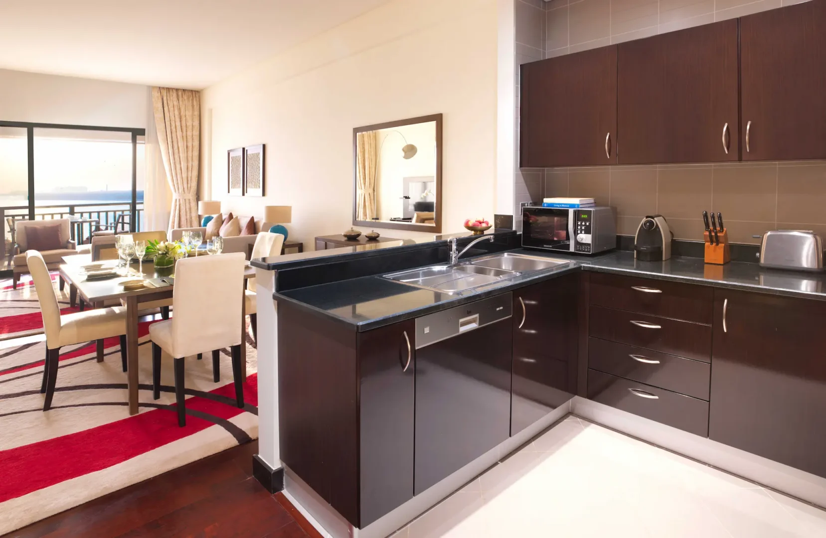 One-Bedroom Apartment kitchen at Anantara The Palm Dubai with modern appliances and fully equipped workspace