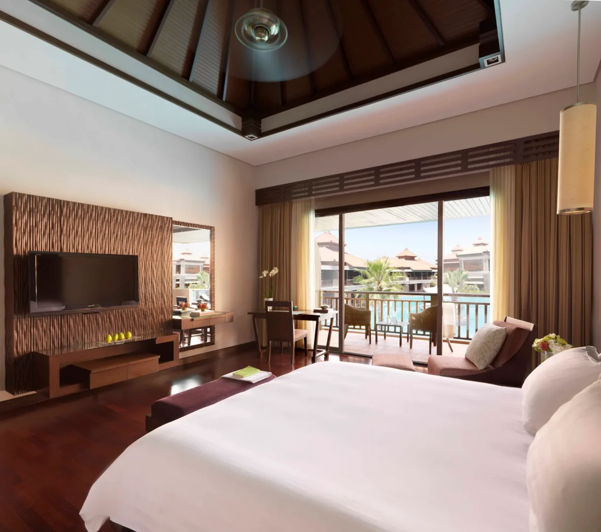 Anantara The Palm Dubai. Premier lagoon view room close up showcasing bed area and TV