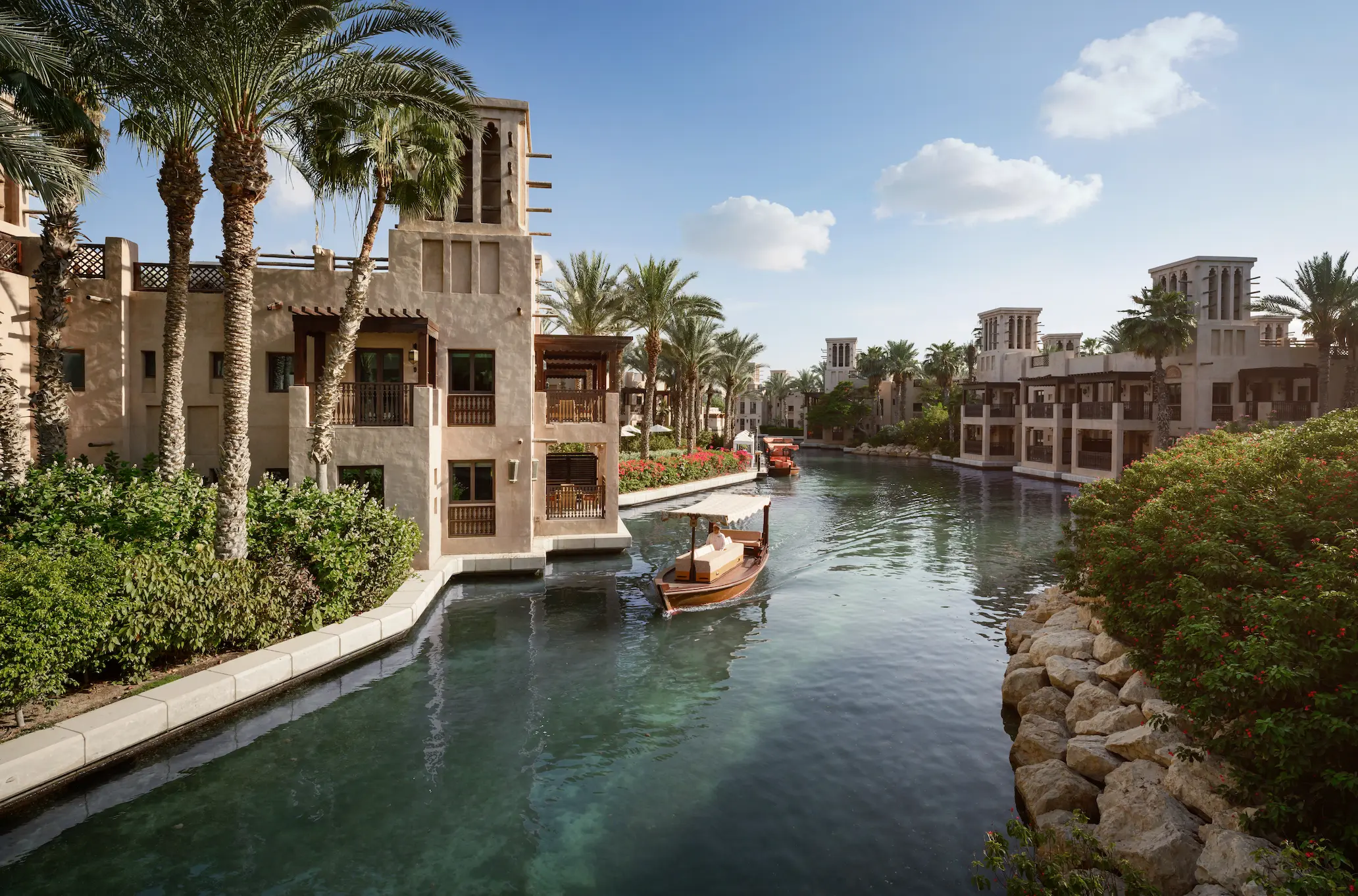 serene waterways at arabian house in jumeirah dar al masyaf surrounded by lush gardens and traditional arabian architecture