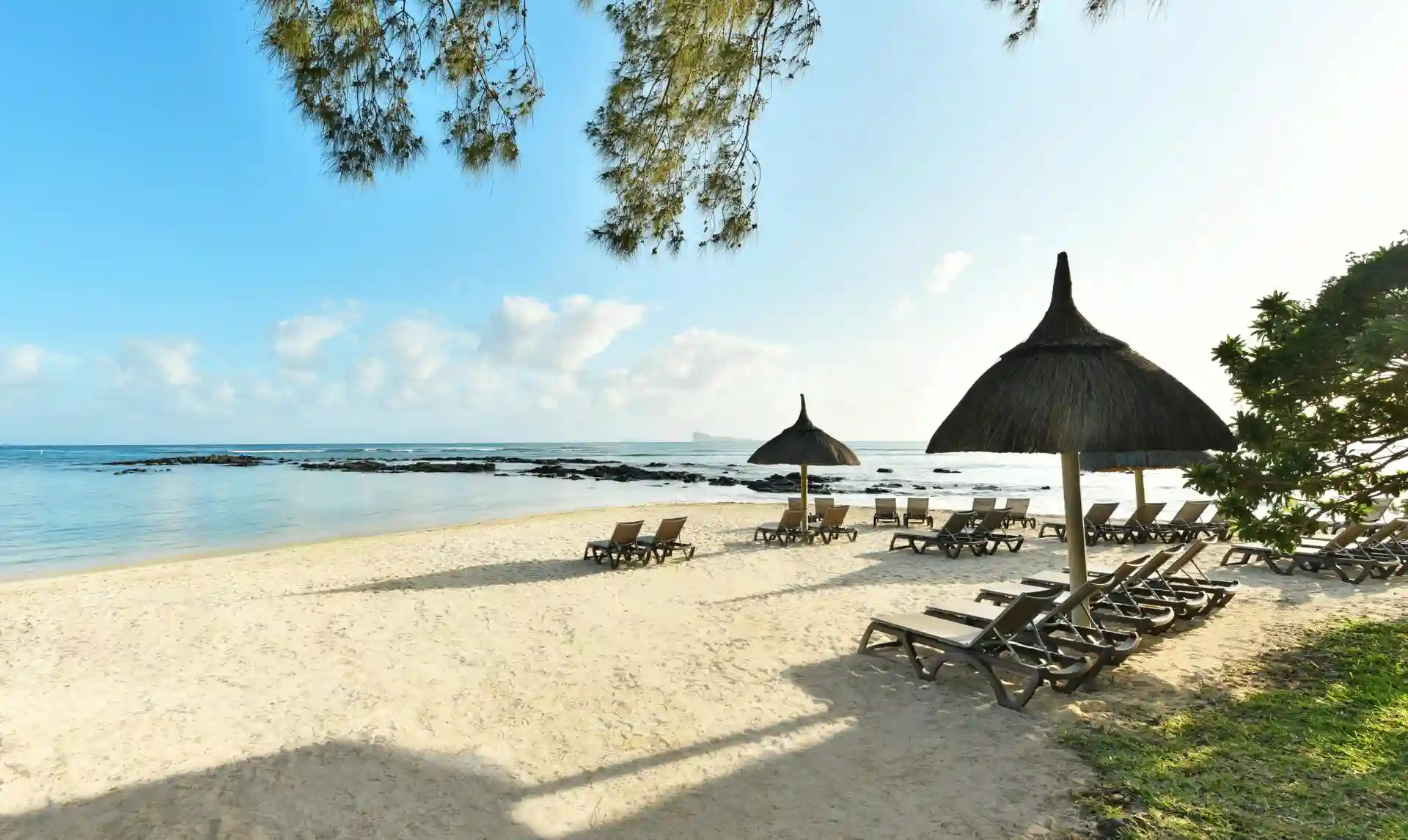white sand beach at cannonier mauritius with turquoise lagoon and palm trees