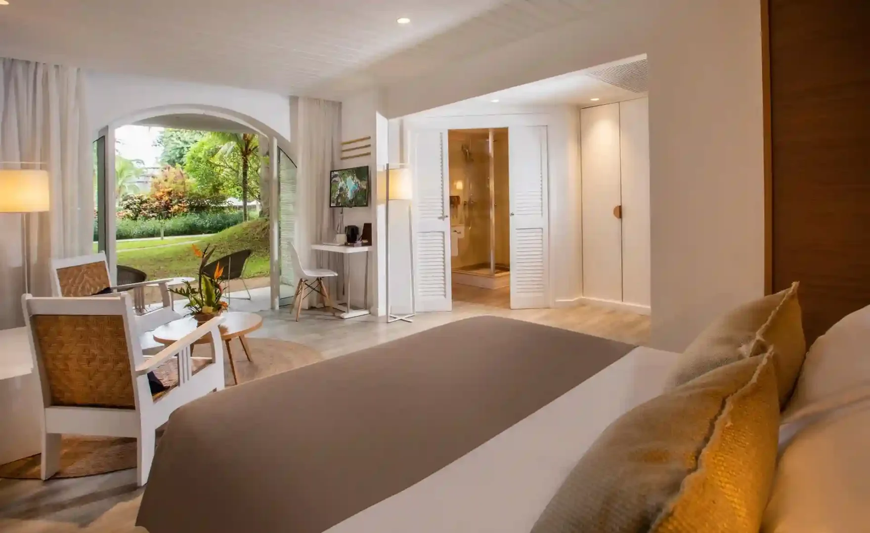 "comfortable bed in standard garden room at canonnier mauritius with tropical garden view