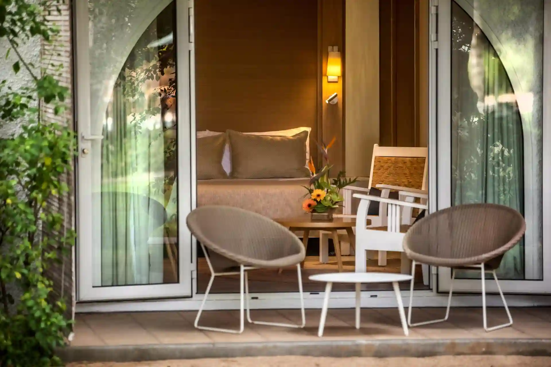 outdoor terrace of standard garden room at canonnier mauritius overlooking tropical gardens