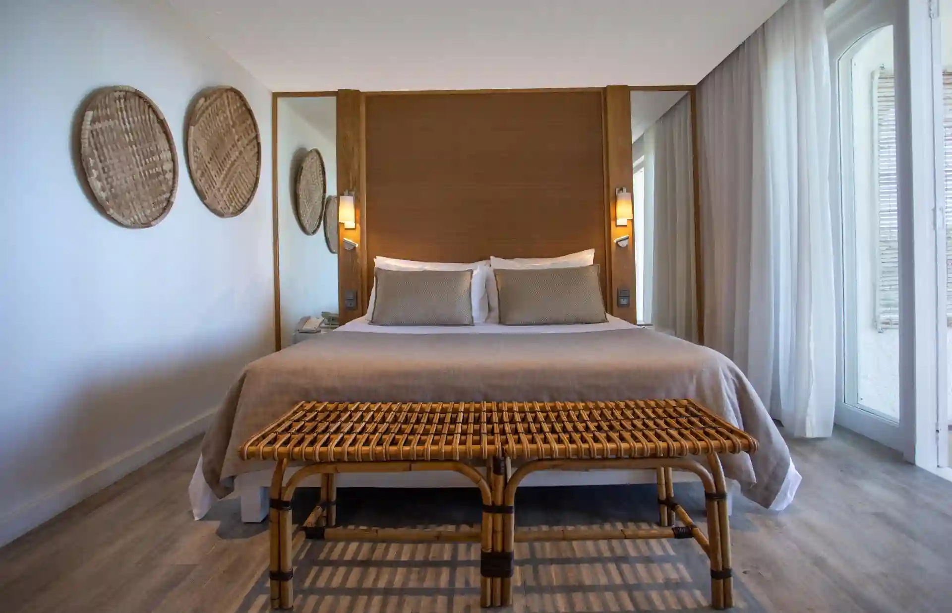 spacious bed in superior room at canonnier mauritius with elegant decor and garden view