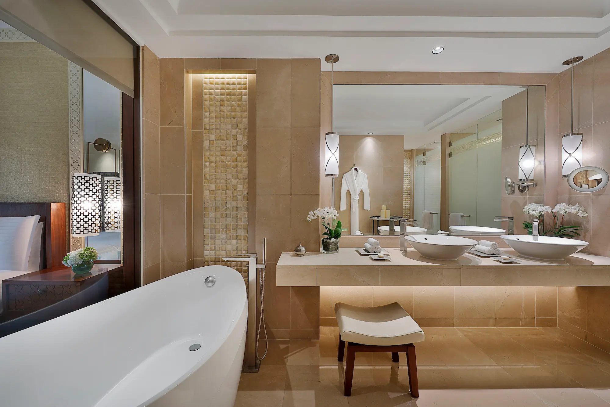 bathroom in club and deluxe room at the ritz-carlton dubai jbr featuring marble interiors deep soaking bathtub walk in shower and luxury amenities in dubai marina