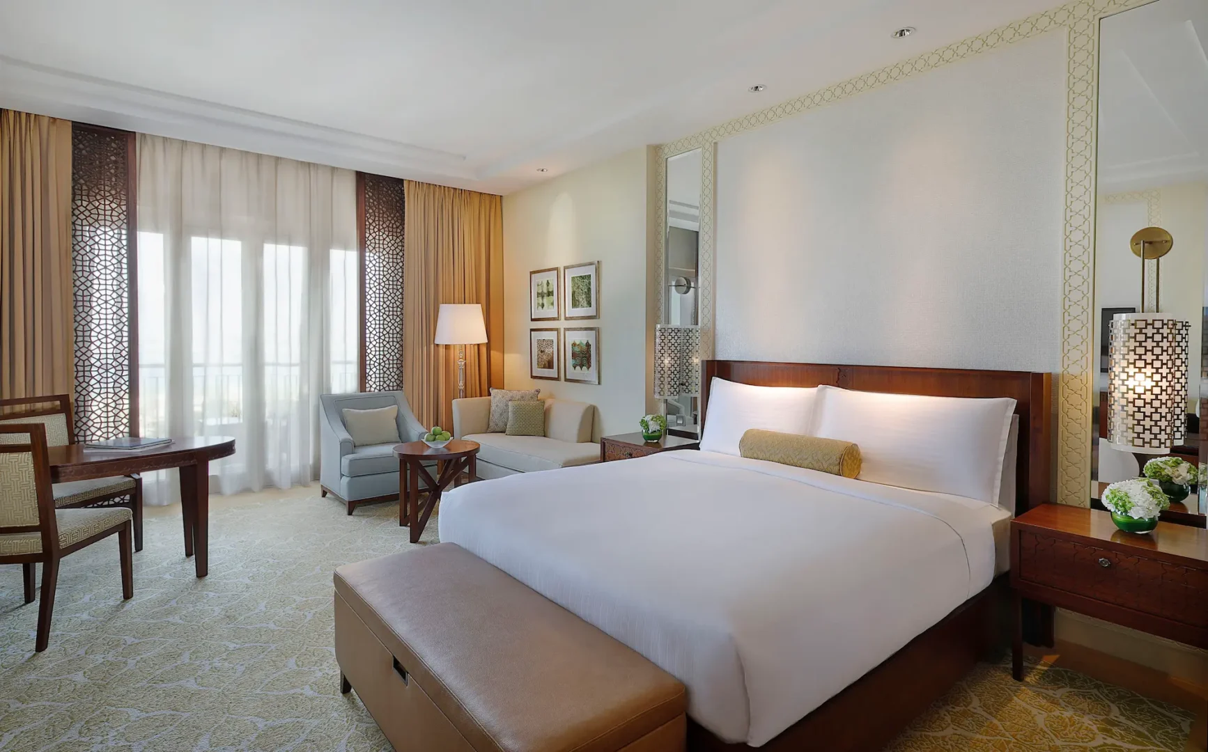 club garden view king room at the ritz-carlton dubai jbr luxury beachfront hotel in dubai marina featuring private balcony overlooking landscaped gardens and elegant interiors