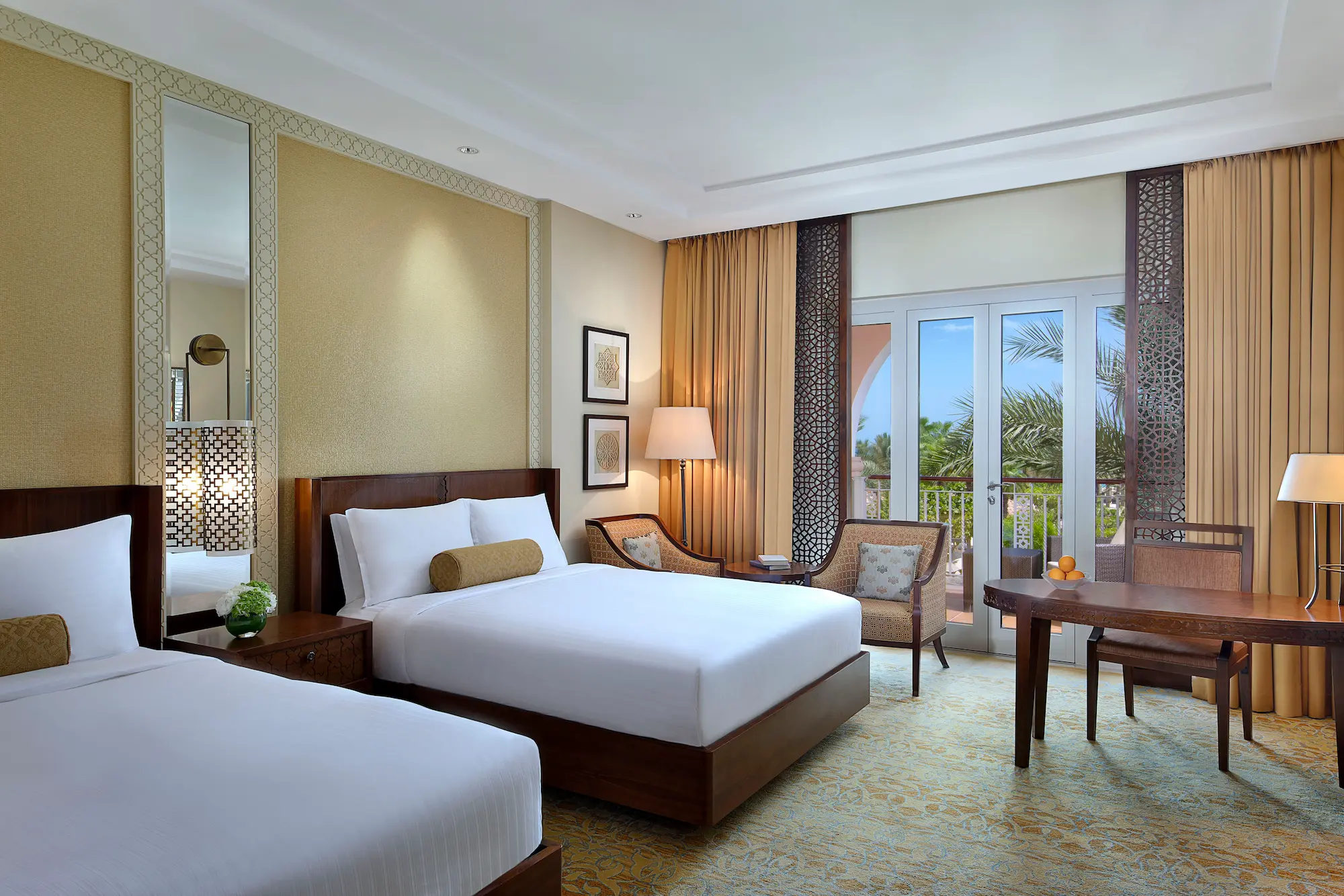 club garden view twin room at the ritz-carlton dubai jbr luxury beachfront hotel in dubai marina featuring private balcony overlooking landscaped gardens and stylish interiors