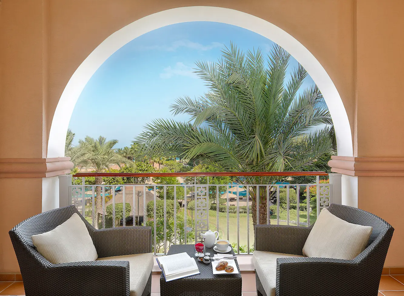 club room with garden view at the ritz-carlton dubai jbr luxury beachfront hotel in dubai marina featuring private balcony overlooking landscaped gardens and elegant interiors