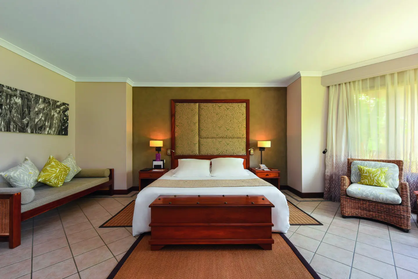 dinarobin beachcomber junior suite bedroom with king bed and elegant tropical decor