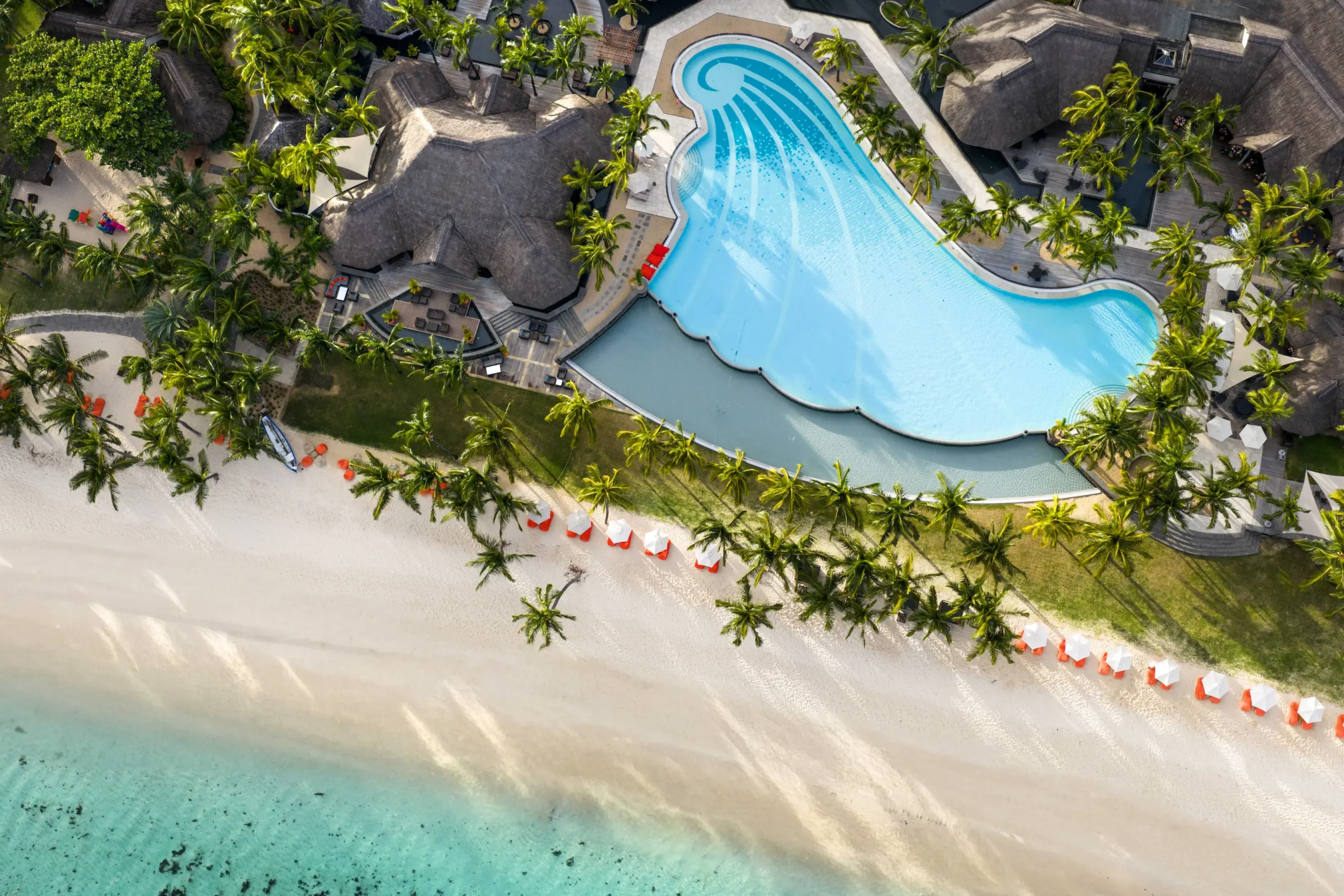 dinarobin beachcomber mauritius aerial view of the resort pool and pristine beach beside the turquoise lagoon