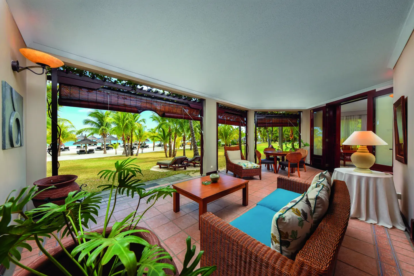 dinarobin senior zen suite terrace with lounge chairs overlooking tropical gardens and ocean view