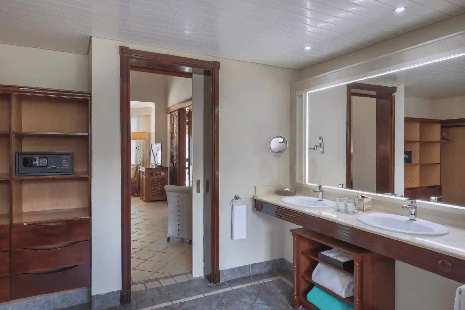 dinarobin suite bathroom with modern fixtures, spacious walk-in shower, and elegant marble finishes