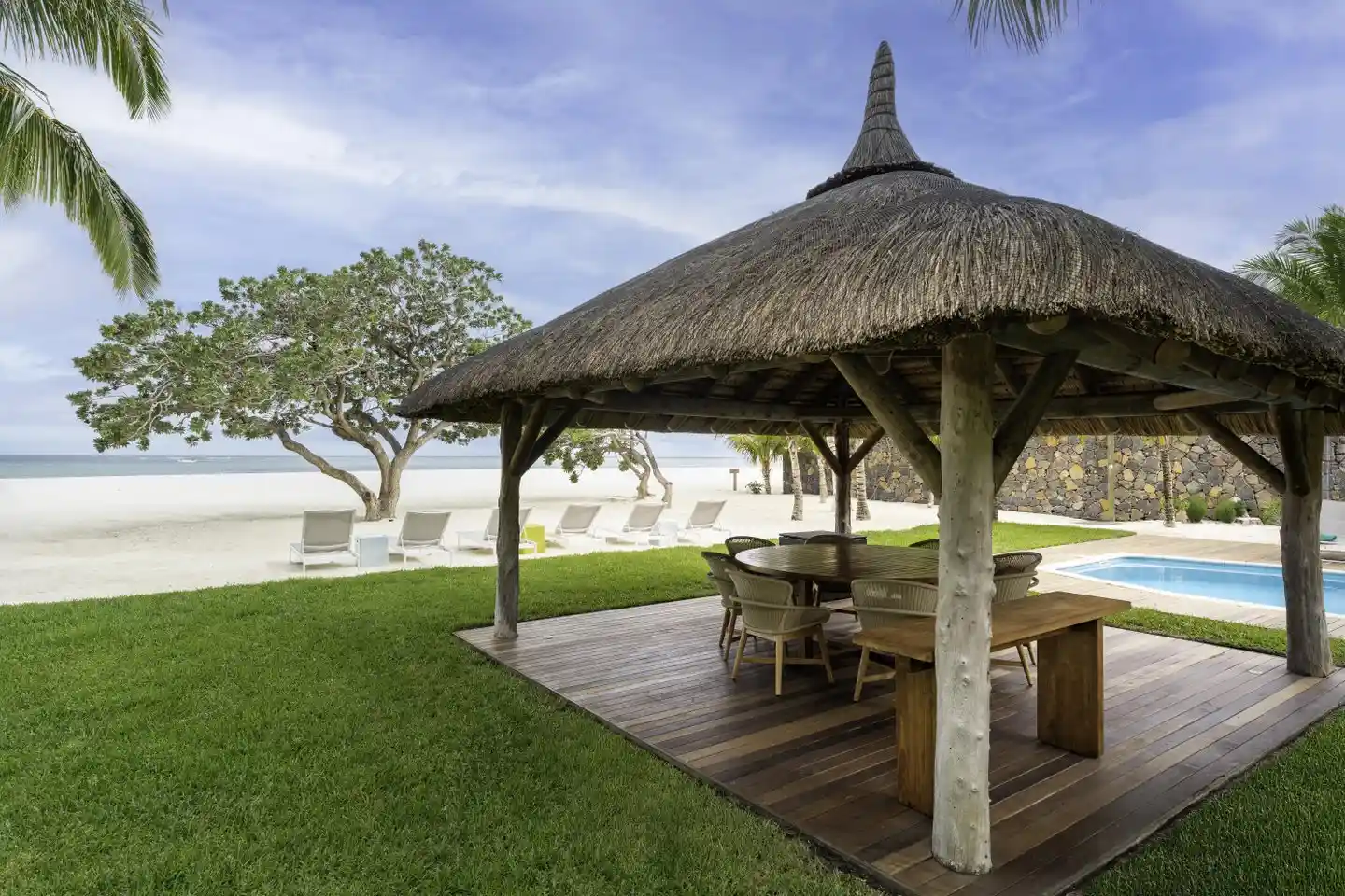 dinarobin villa private pool with sun loungers and lush tropical landscaping