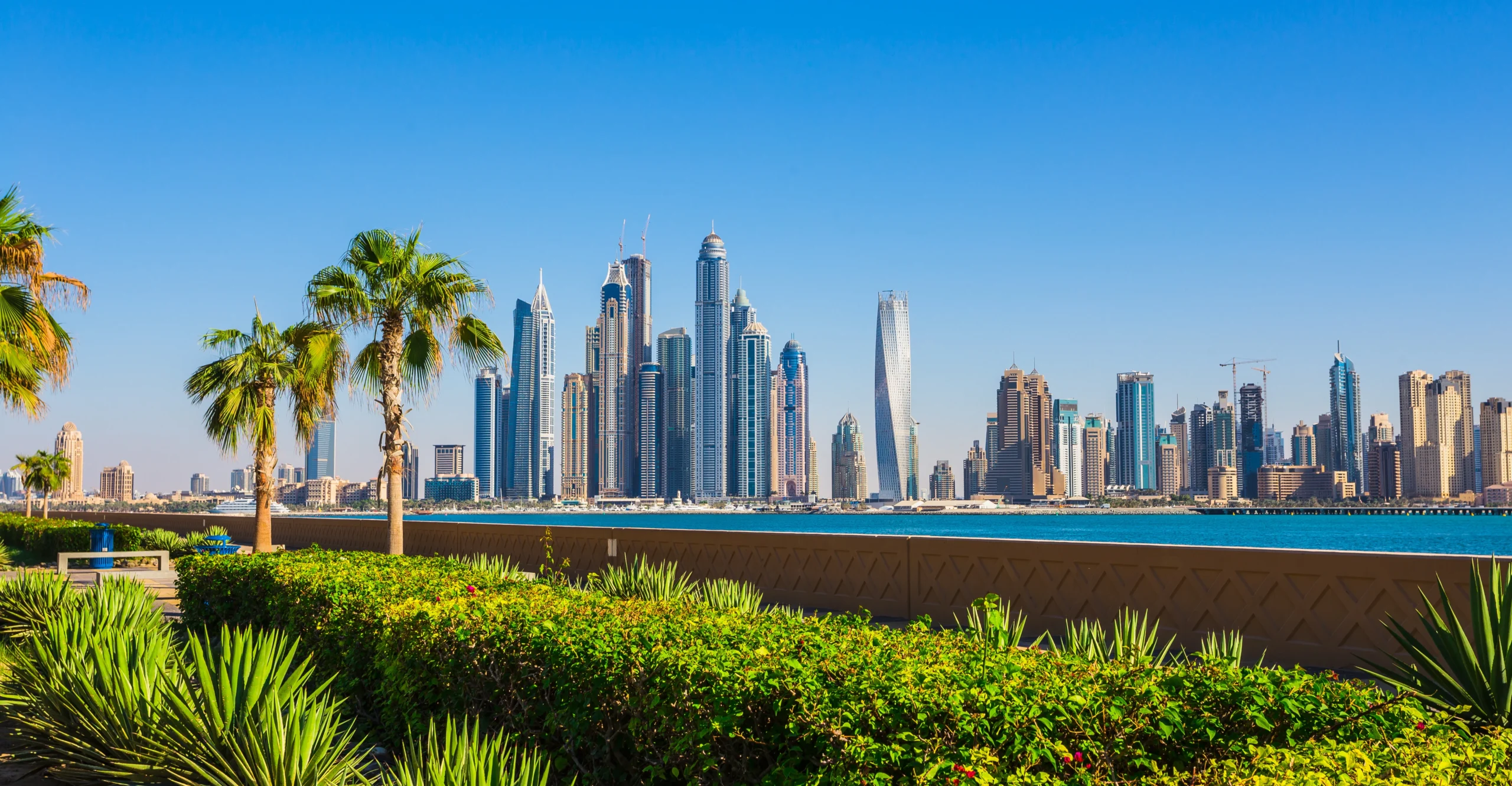 panoramic view of dubai cityscape featuring skyscrapers, modern architecture, and waterfront skyline