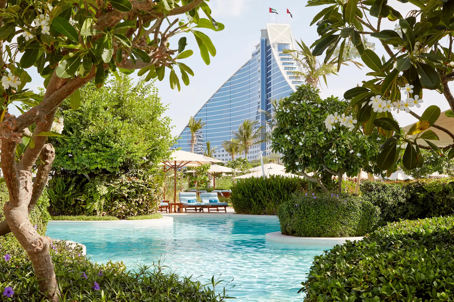 executive pool club pool landscape at Jumeirah Beach Hotel with infinity-style pool, sun loungers and panoramic arabian gulf views