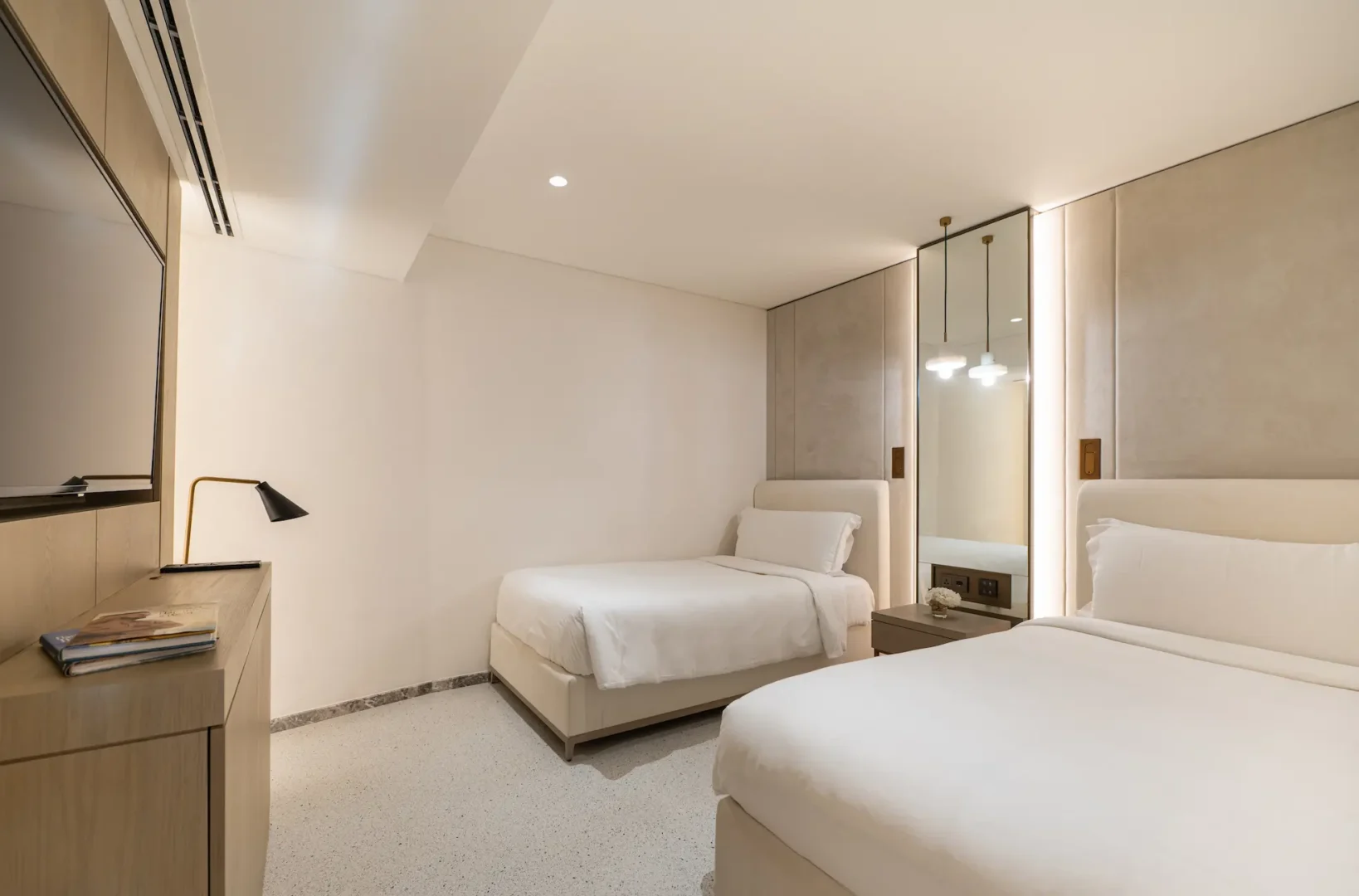 twin bedroom in family garden suite at Jumeirah Beach Hotel with twin beds, modern décor and garden views