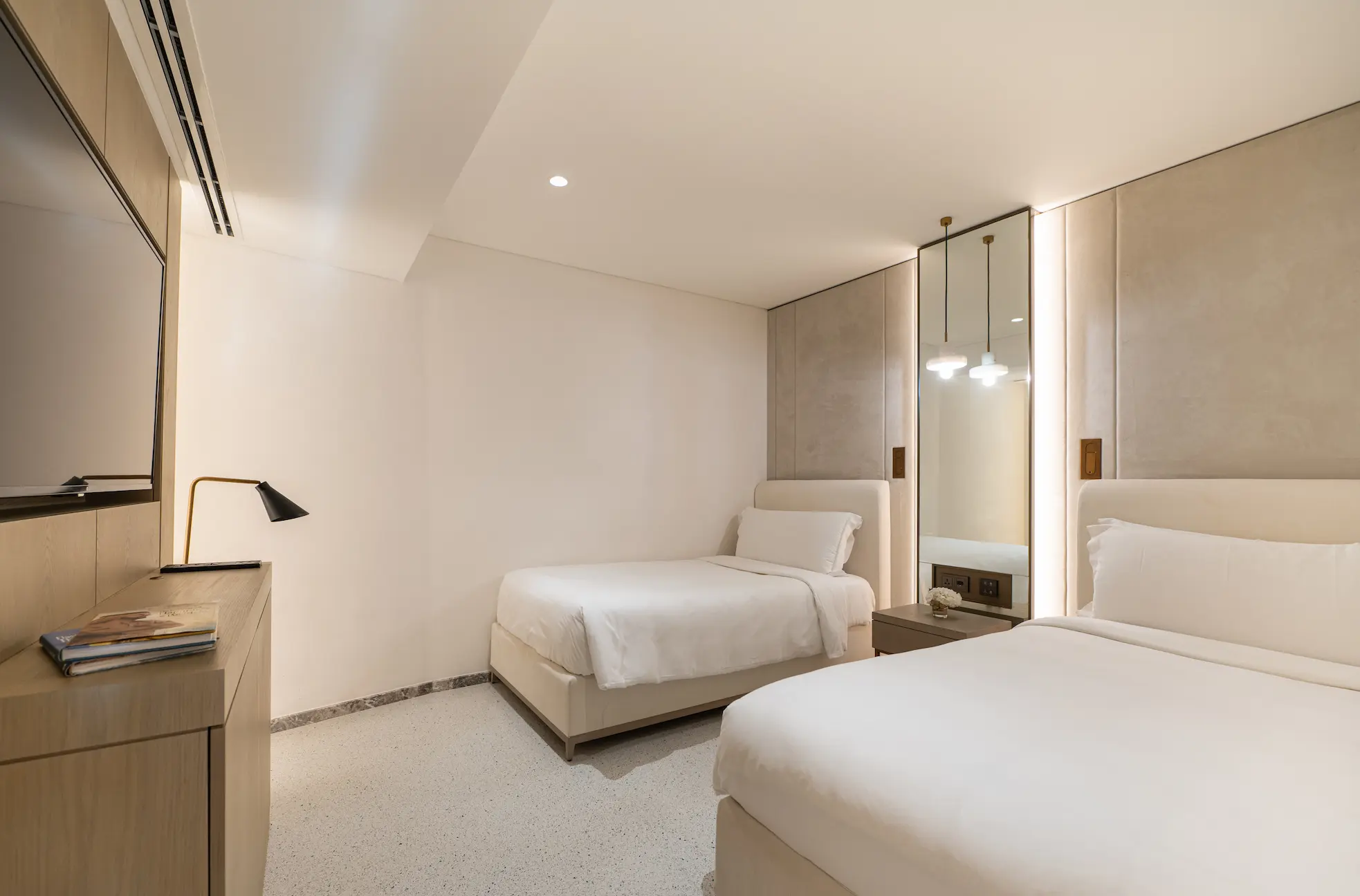 twin bedroom in family garden suite at Jumeirah Beach Hotel with twin beds, modern décor and garden views