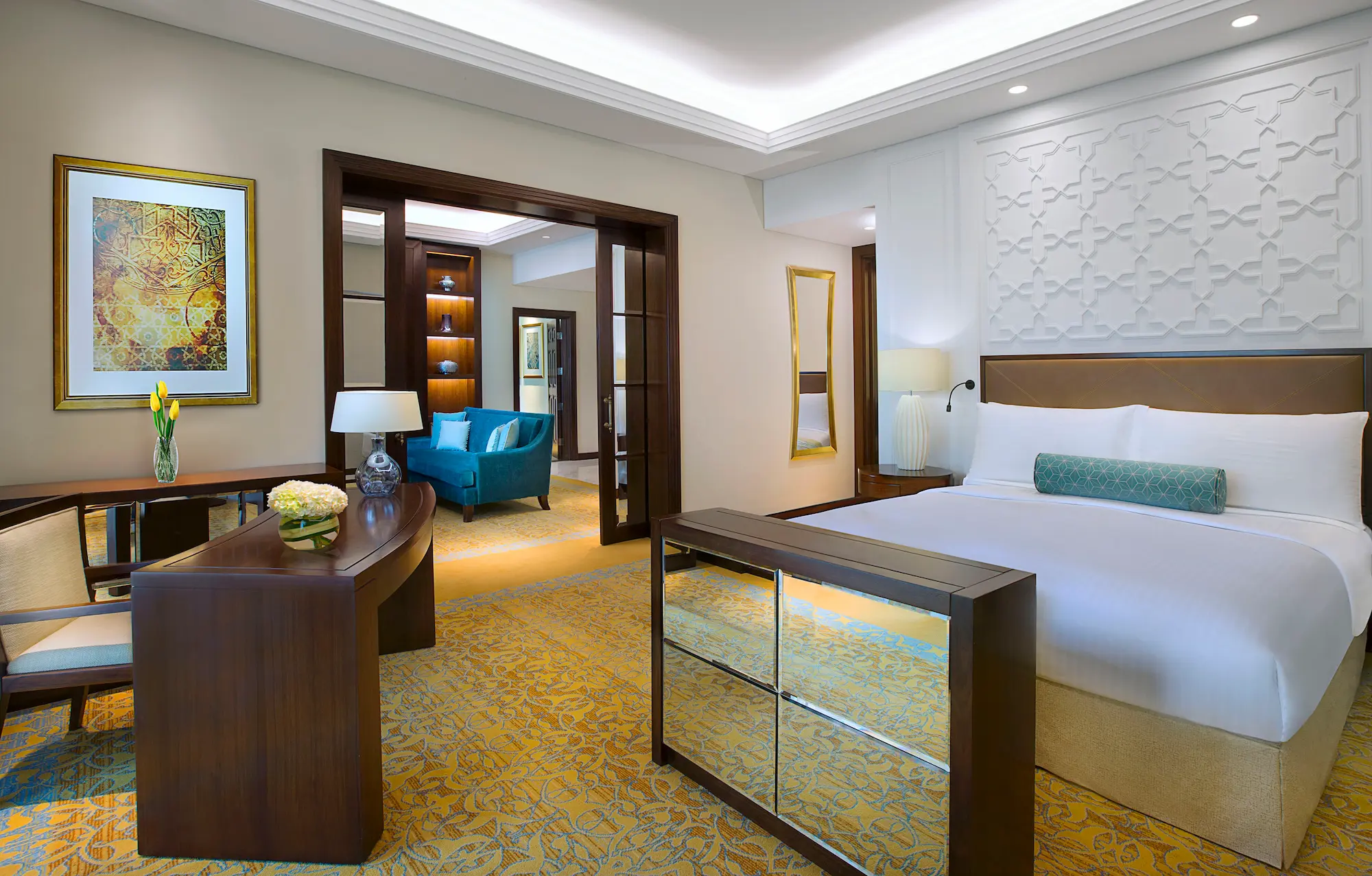 bedroom in family suite at the ritz-carlton dubai jbr luxury beachfront hotel featuring king and twin beds, elegant interiors, and comfortable living space in dubai marina