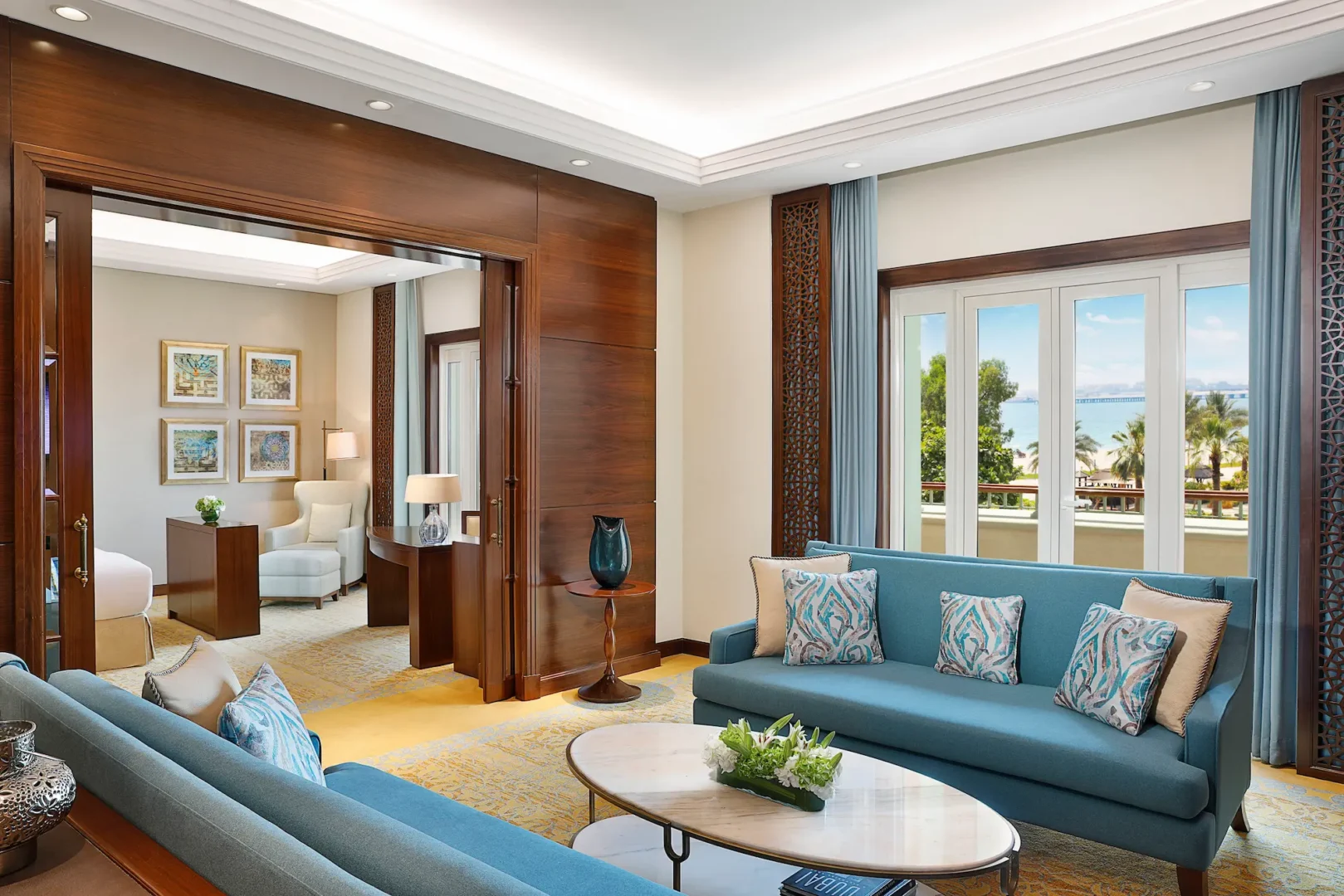 living room in family suite at the ritz-carlton dubai jbr luxury beachfront hotel featuring elegant seating, modern interiors, and views of landscaped gardens or pool in dubai marina