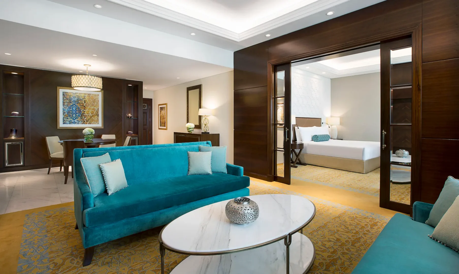 living room in family suite at the ritz-carlton dubai jbr luxury beachfront hotel featuring spacious seating area, contemporary interiors, and large windows with garden or pool views in dubai marina
