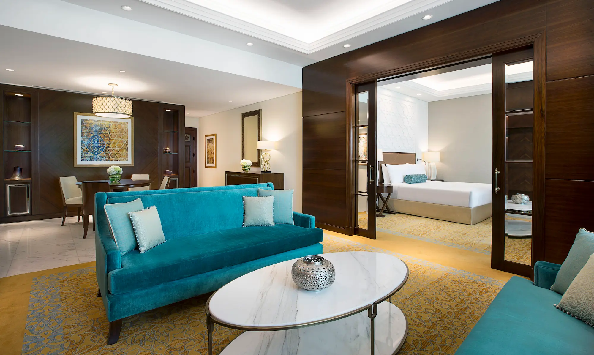 living room in family suite at the ritz-carlton dubai jbr luxury beachfront hotel featuring spacious seating area, contemporary interiors, and large windows with garden or pool views in dubai marina