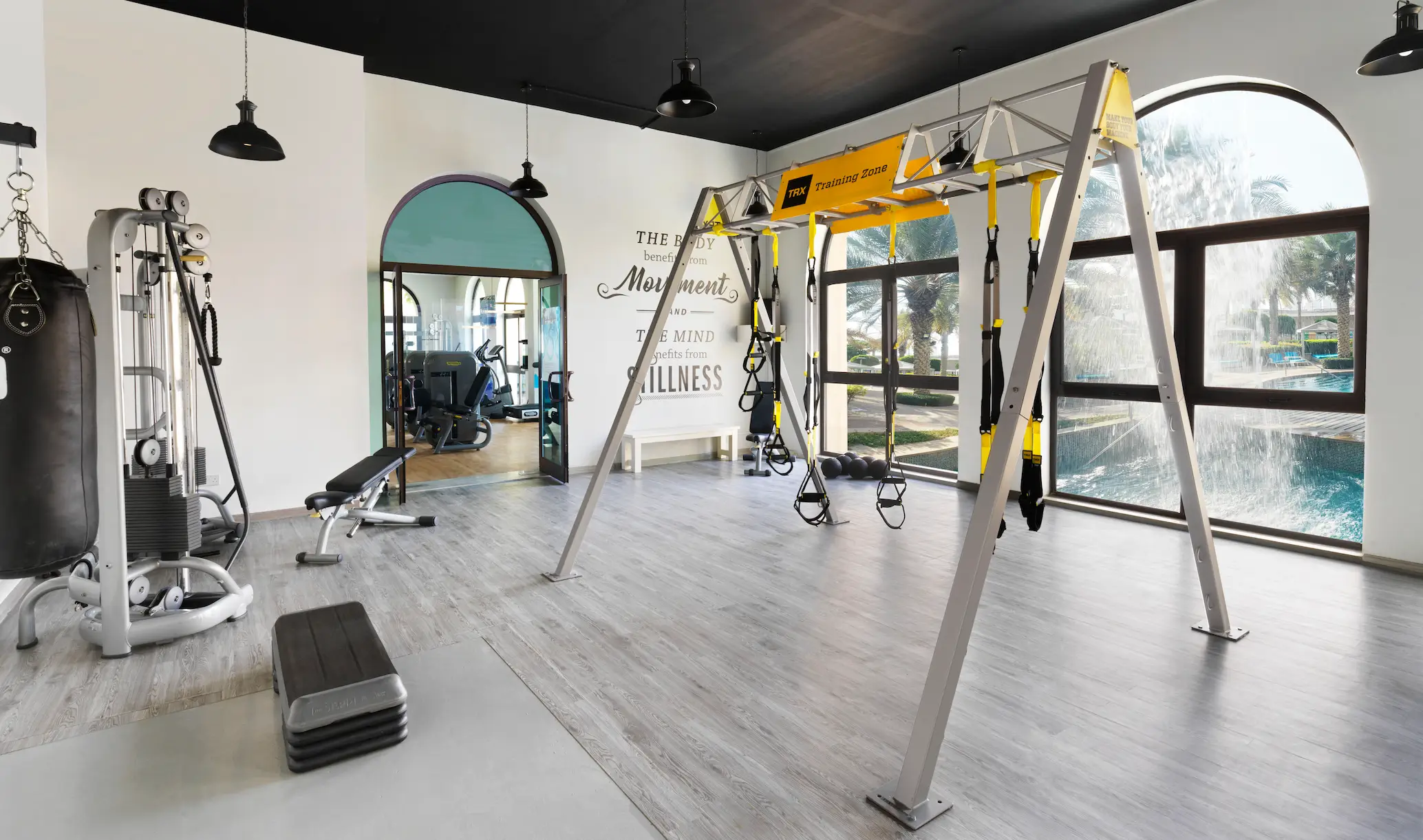 modern fitness gym at fairmont the palm dubai health club with workout equipment