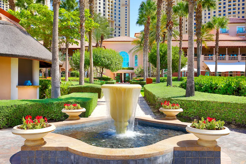 garden fountain at the ritz-carlton dubai jbr featuring landscaped gardens, tranquil water feature, and luxury resort surroundings in dubai marina