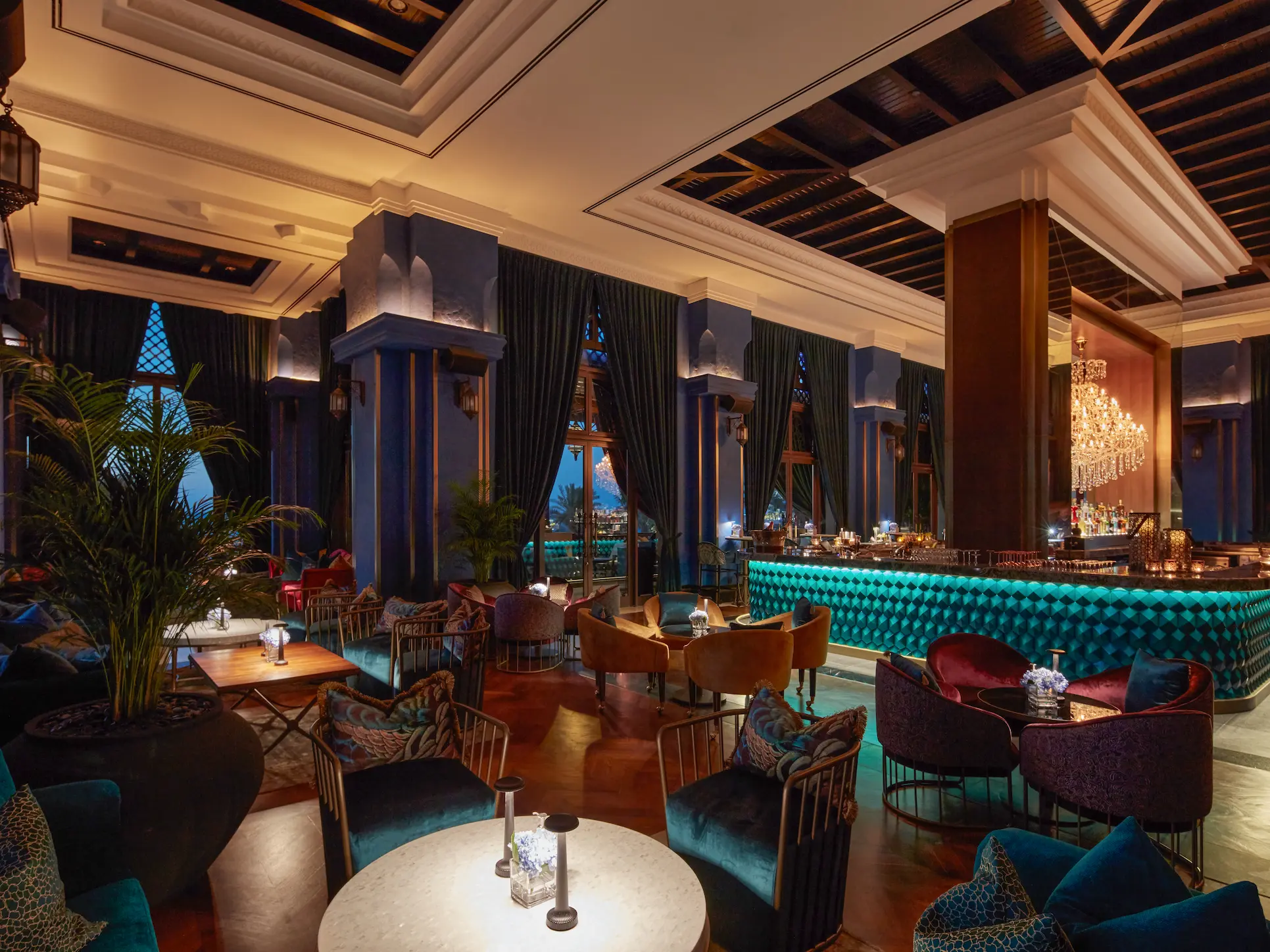bahri bar interior at jumeirah mina a salam dubai featuring rich wooden finishes, arabian-inspired décor, ambient lighting and elevated views across the resort waterways and arabian gulf