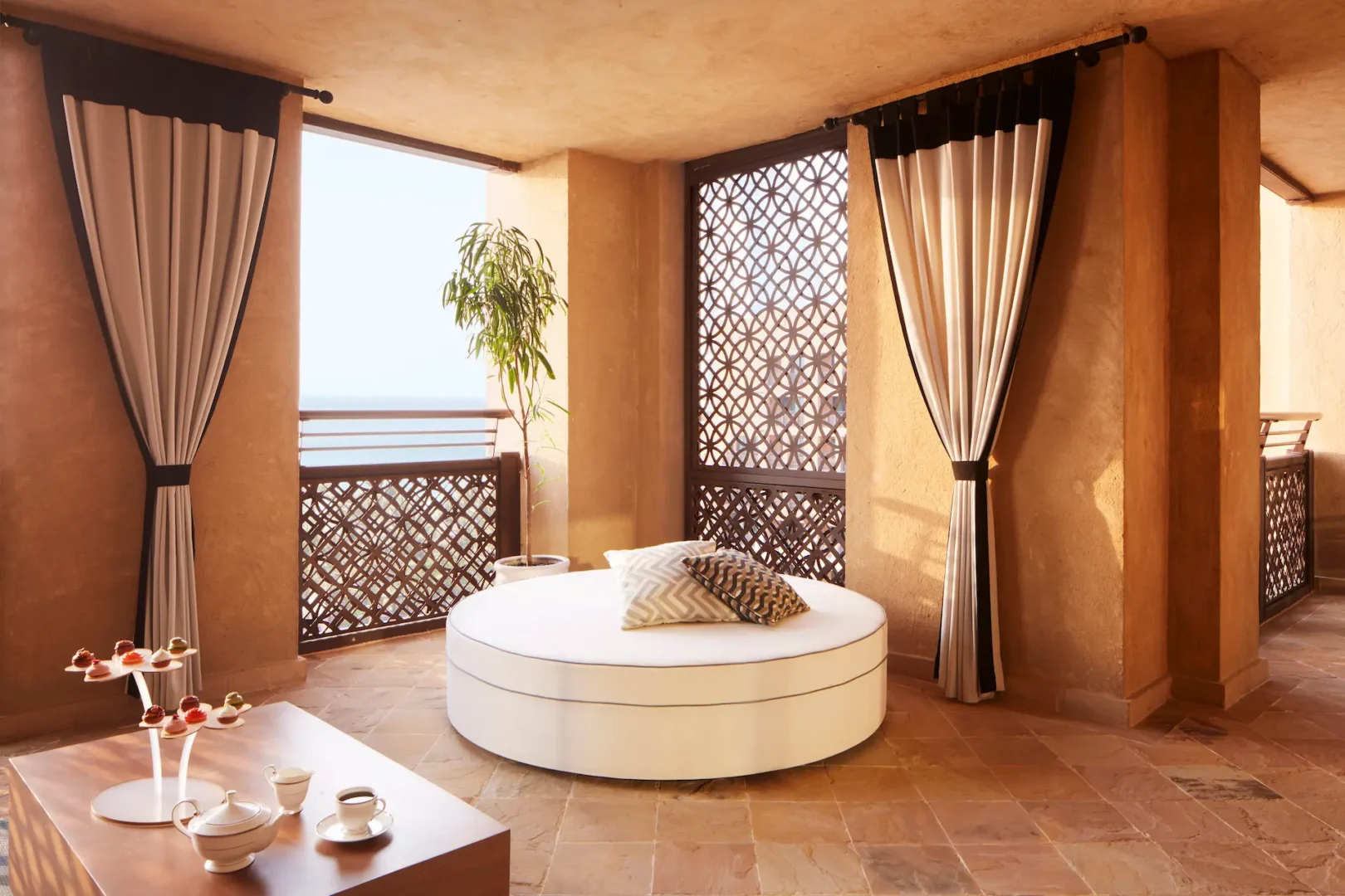 ocean suite balcony at jumeirah mina a salam dubai featuring private terrace seating with sweeping views across the arabian gulf and landscaped resort surroundings