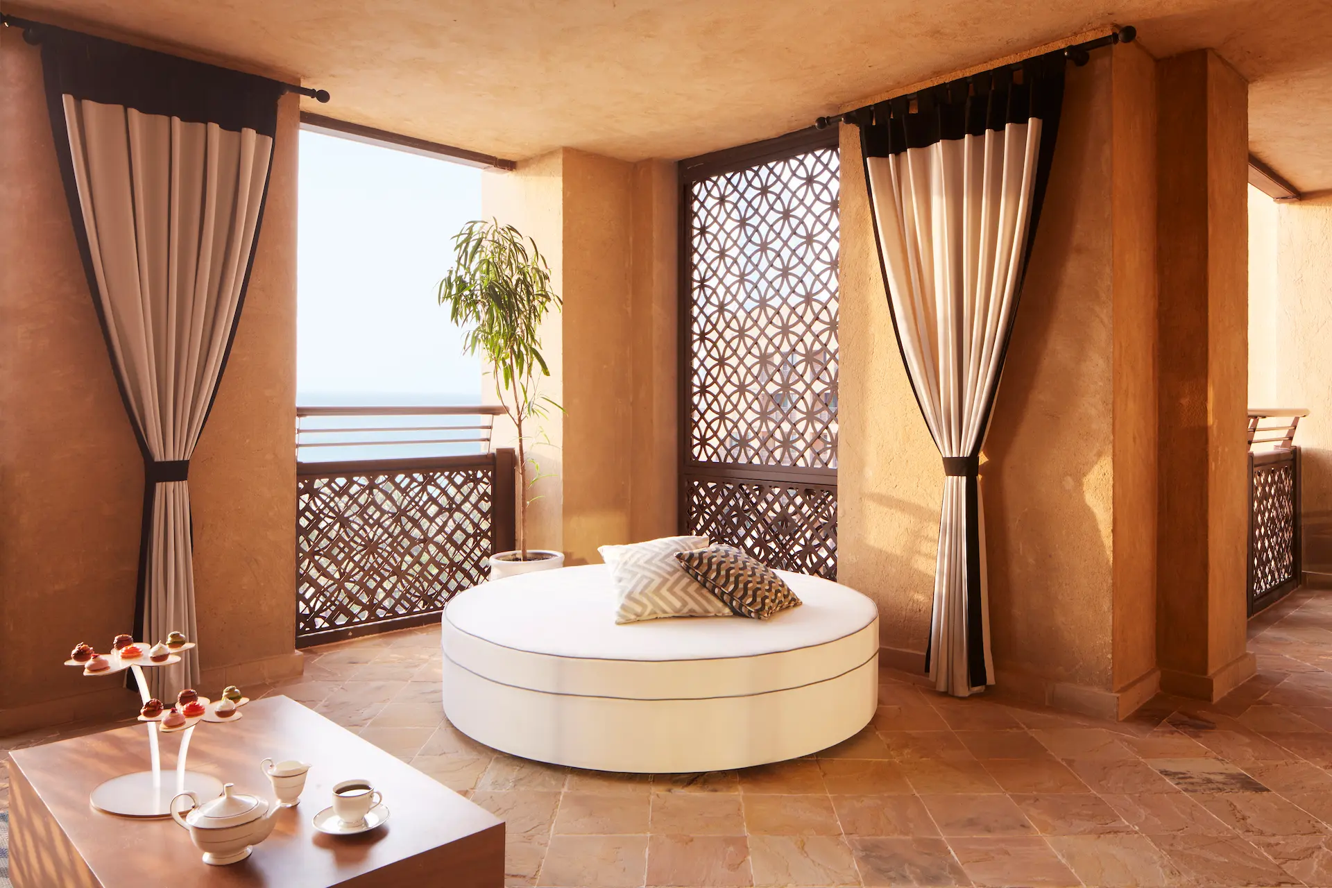 ocean suite balcony at jumeirah mina a salam dubai featuring private terrace seating with sweeping views across the arabian gulf and landscaped resort surroundings
