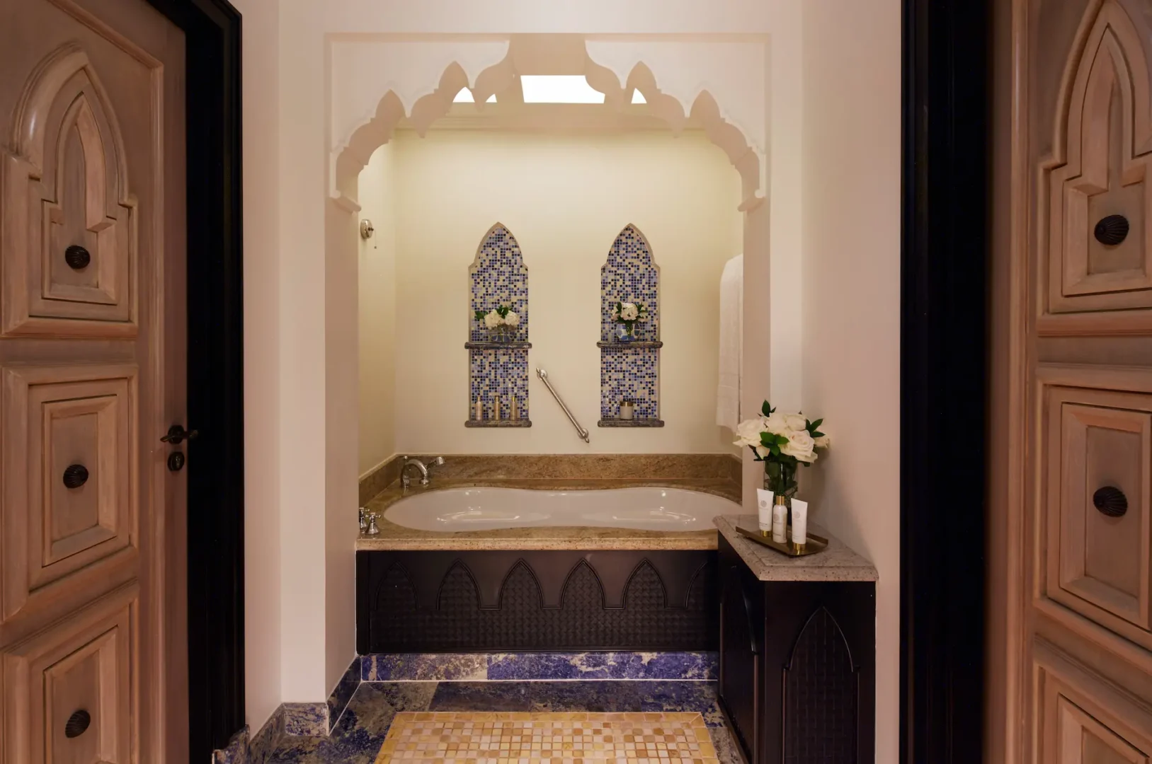 ocean suite bathroom at jumeirah mina a salam dubai featuring marble finishes, dual vanity sinks, walk-in shower and soaking bathtub with elegant arabian detailing