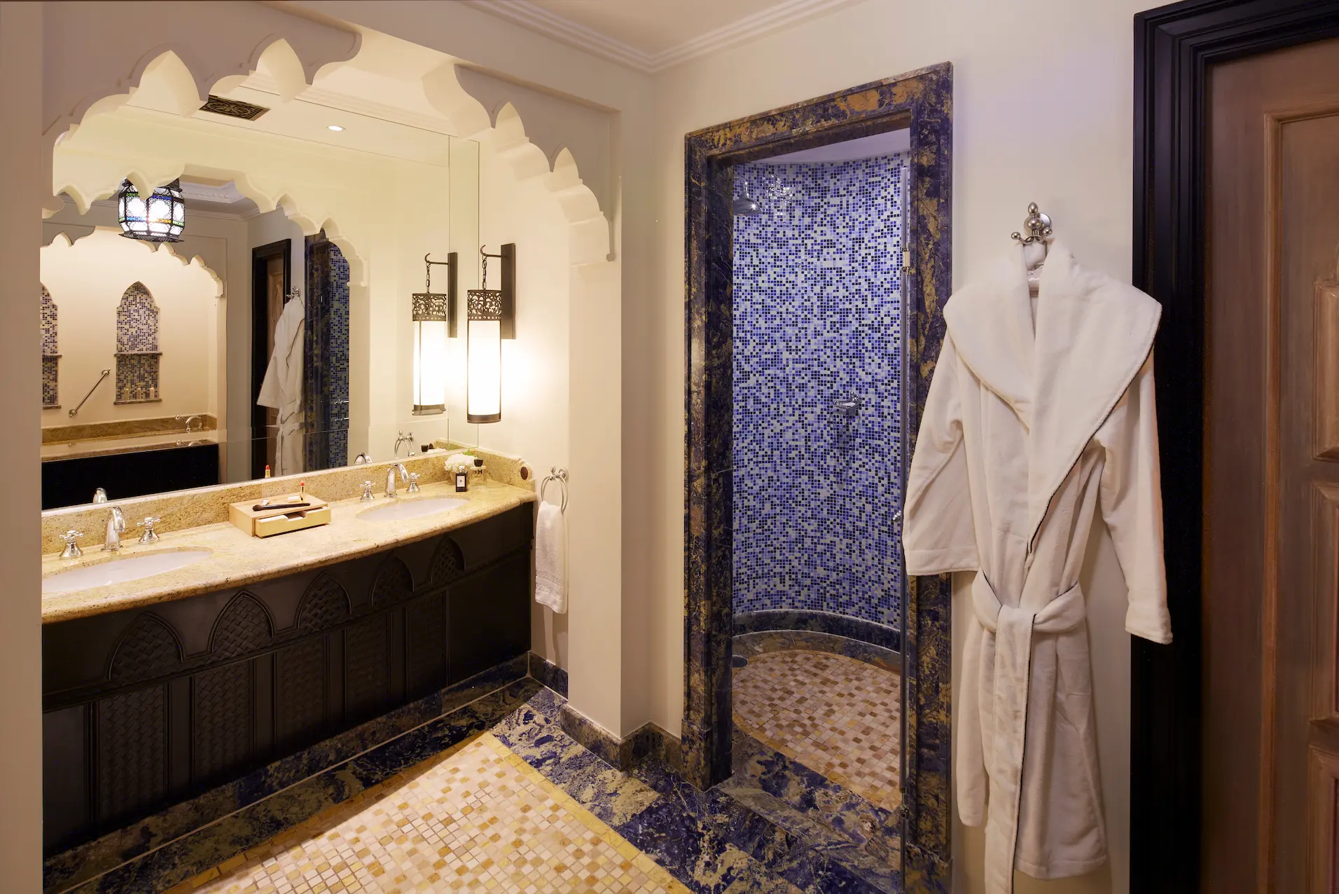 ocean suite bathroom at jumeirah mina a salam dubai featuring marble flooring, freestanding bathtub, walk-in shower and elegant arabian-style detailing