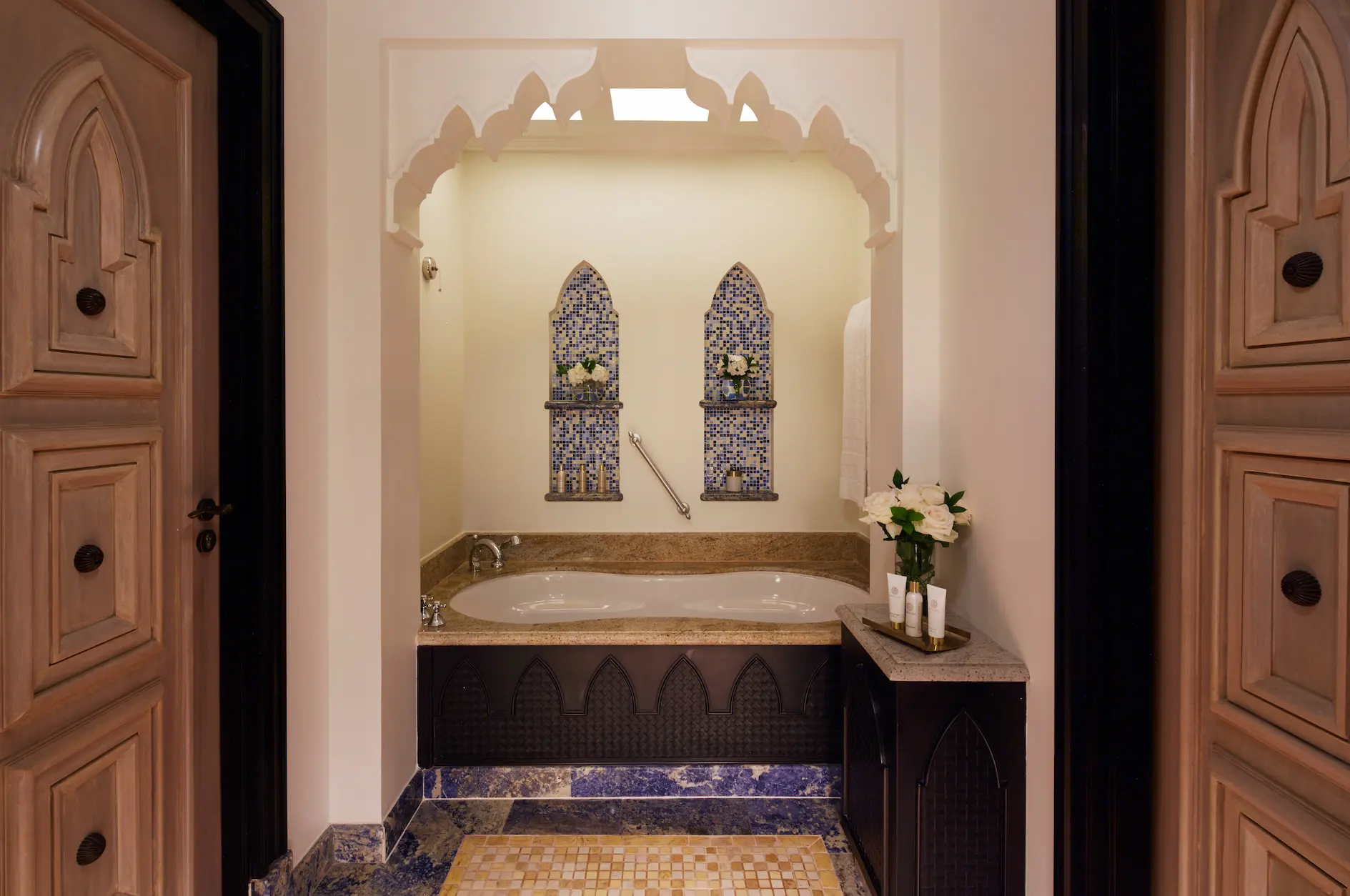 ocean suite bathroom at jumeirah mina a salam dubai featuring marble finishes, dual vanity sinks, walk-in shower and soaking bathtub with elegant arabian detailing