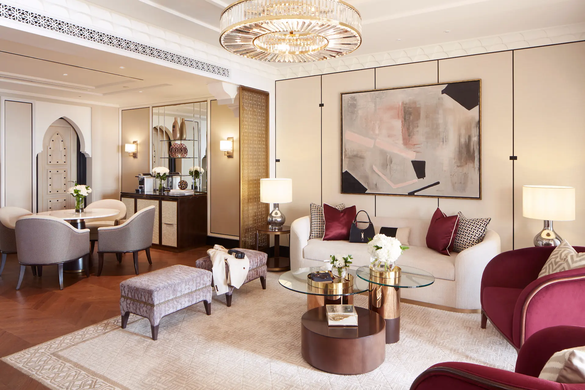 ocean suite living and dining area at jumeirah mina a salam dubai featuring spacious lounge seating, separate dining table, floor-to-ceiling windows and views towards the arabian gulf