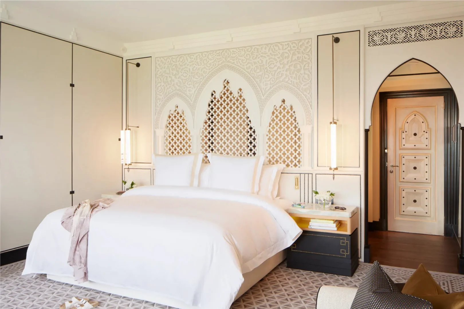 arabian club room bedroom at jumeirah mina al salam dubai featuring elegant arabian design, plush king-size bed, warm wooden accents and private balcony with resort or waterway views